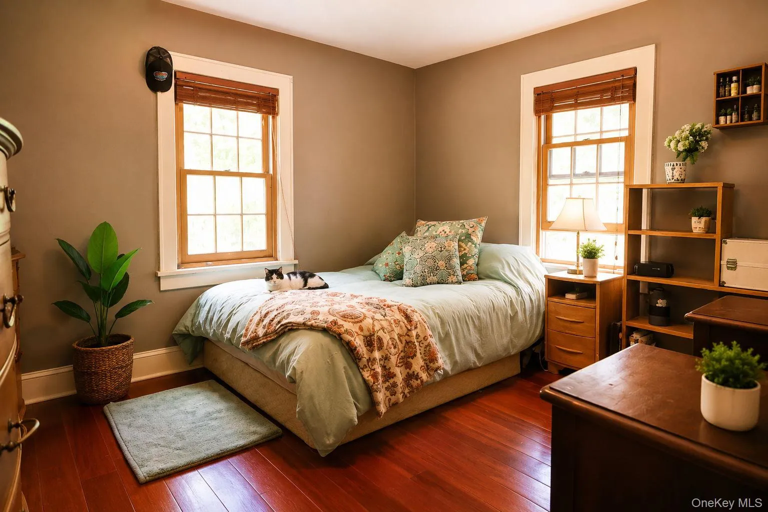 Main bedroom featuring Brazilian cherry wood flooring and two sash windows with wood blinds Main bedroom featuring Brazilian cherry wood flooring and two sash windows with wood blinds