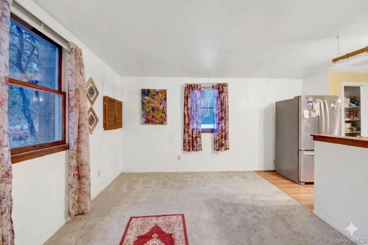 Unfurnished room featuring light carpet Unfurnished room featuring light carpet