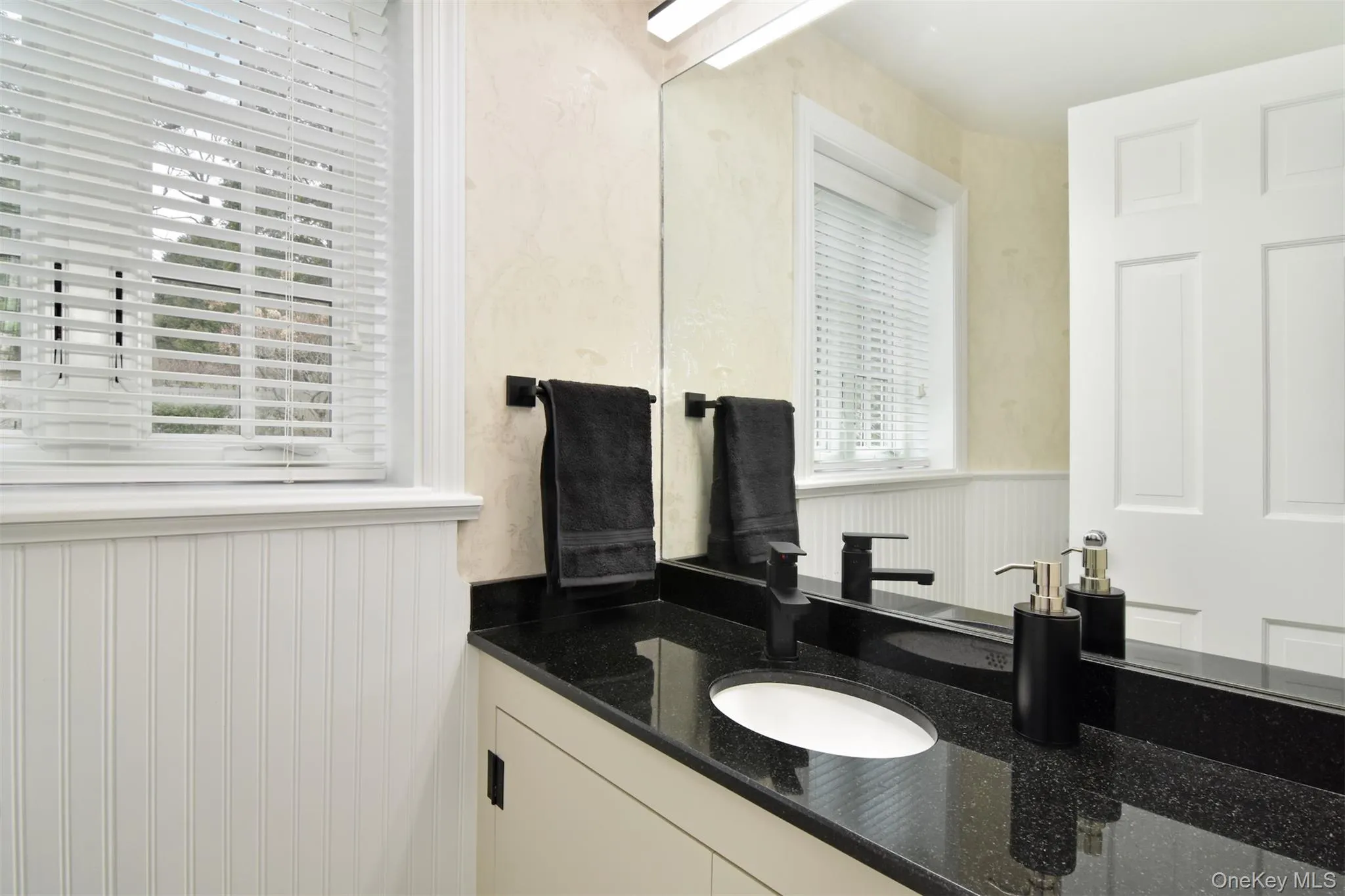 A Powder Room with lovely counters and modern fixtures A Powder Room with lovely counters and modern fixtures