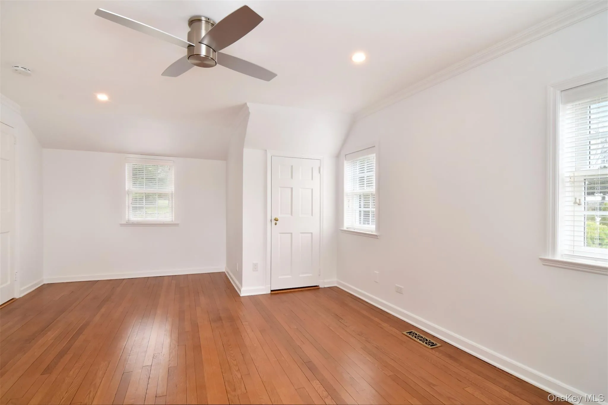 Another view of bedroom with lofted ceiling, hardwood / wood-style floors, recessed lighting, and ceiling fan Another view of bedroom with lofted ceiling, hardwood / wood-style floors, recessed lighting, and ceiling fan