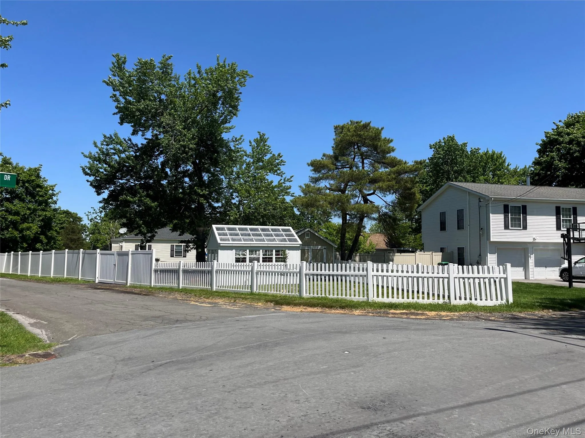 Long white fence wraps around 3 sides of the block. Corner property! Long white fence wraps around 3 sides of the block. Corner property!