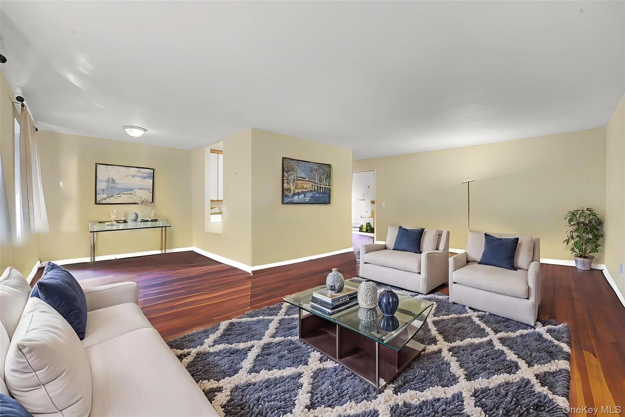 **Virtually Staged** Spacious living area featuring rich wood-finish flooring, light-toned walls, and recessed lighting **Virtually Staged** Spacious living area featuring rich wood-finish flooring, light-toned walls, and recessed lighting