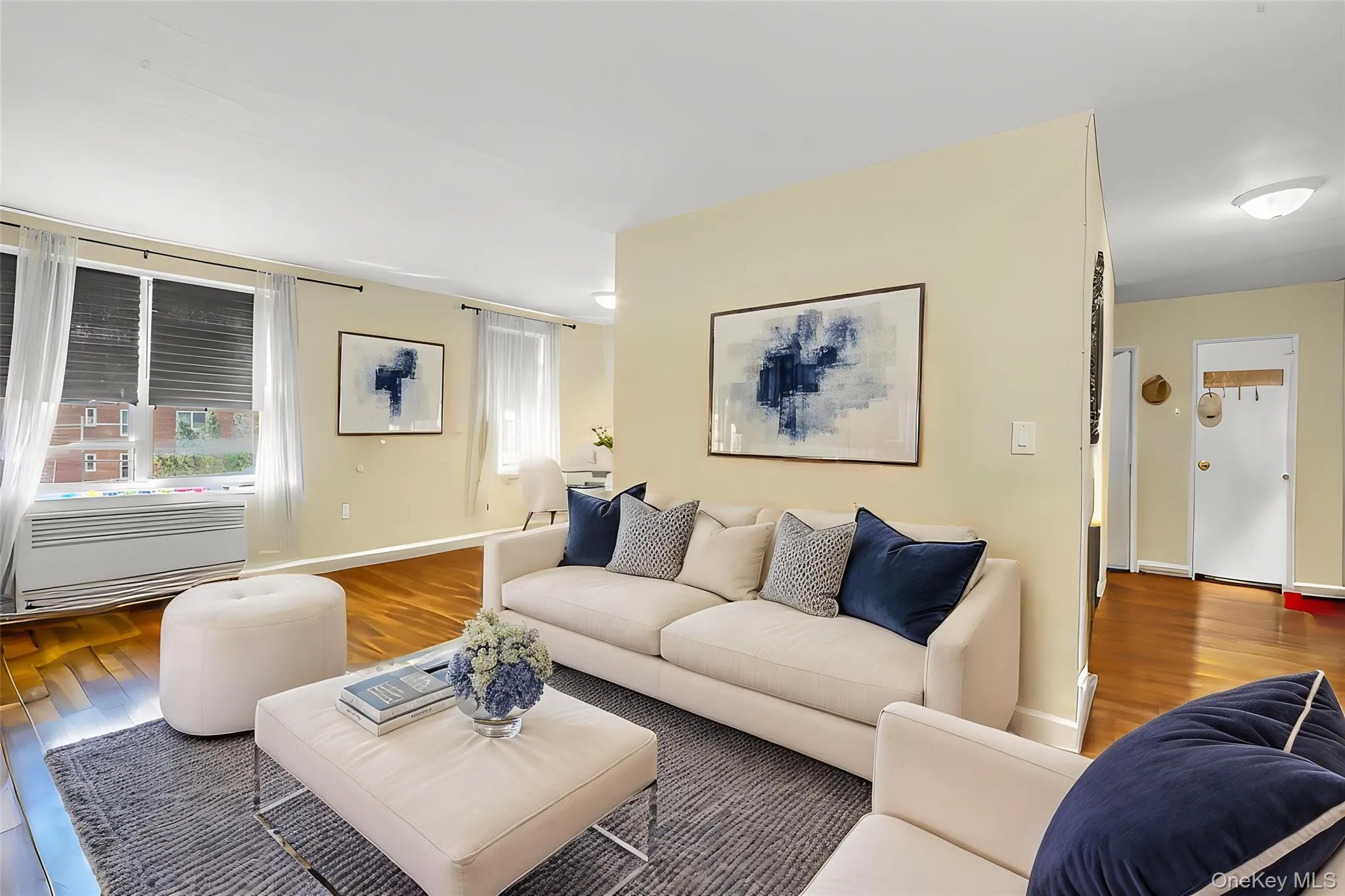**Virtually Staged** Living area with wood-finish flooring, light-toned walls, and multiple windows with blinds **Virtually Staged** Living area with wood-finish flooring, light-toned walls, and multiple windows with blinds