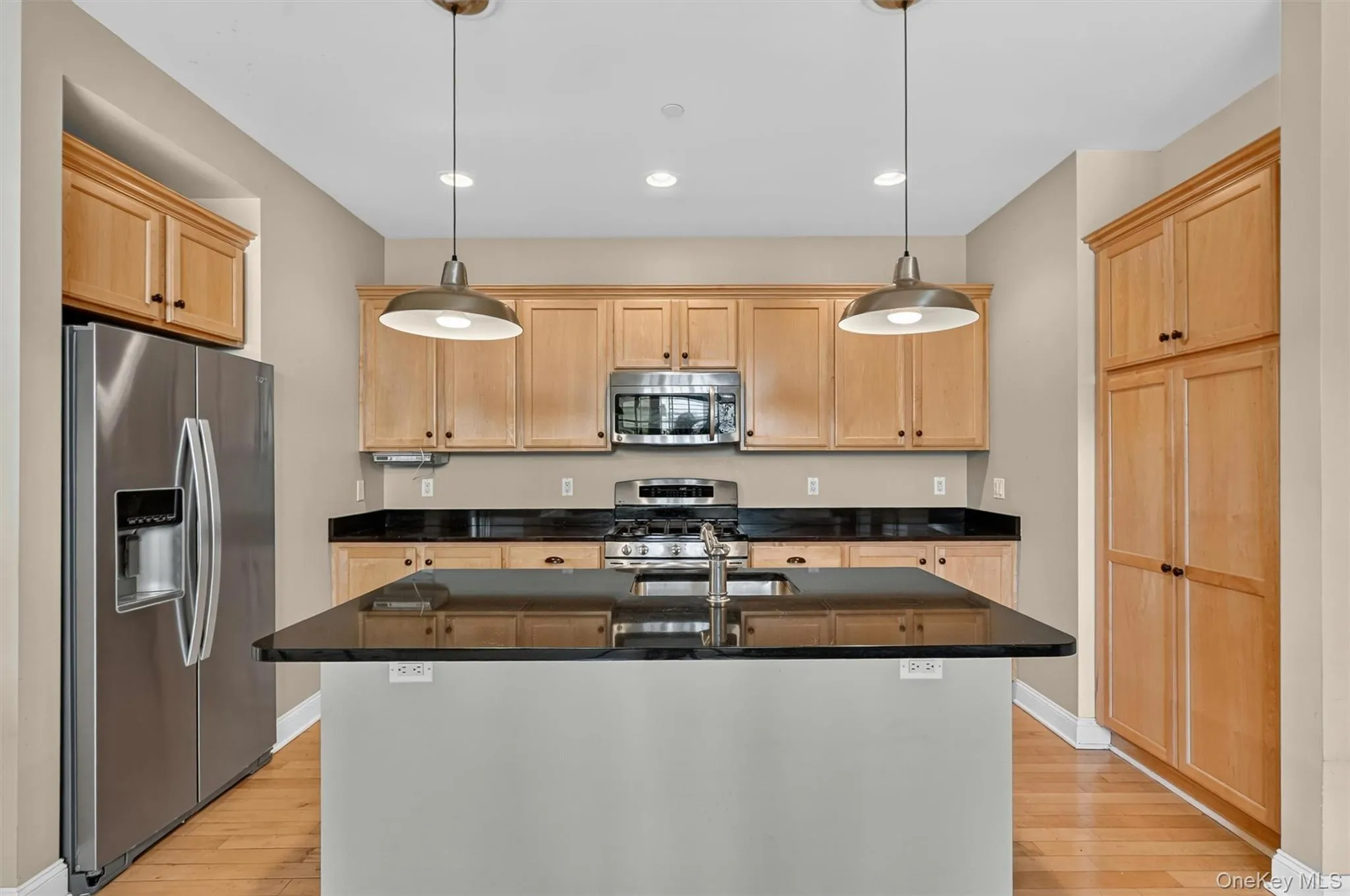 Abundant cabinetry, granite countertops, stainless steel appliances, and a central island for everyday function. Abundant cabinetry, granite countertops, stainless steel appliances, and a central island for everyday function.