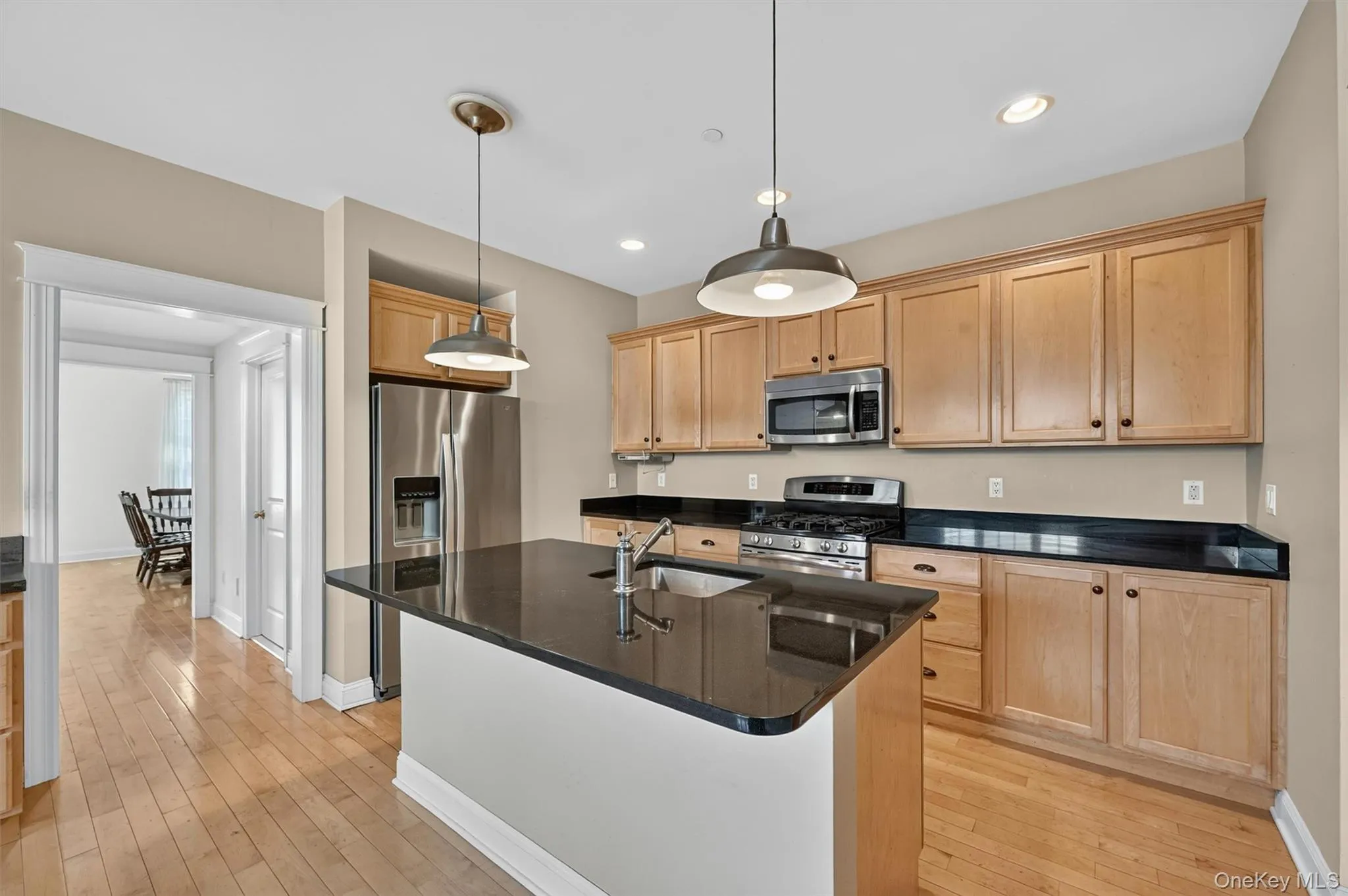 The kitchen offers generous workspace, warm wood cabinetry, granite countertops and easy flow into the adjoining living areas. The kitchen offers generous workspace, warm wood cabinetry, granite countertops and easy flow into the adjoining living areas.