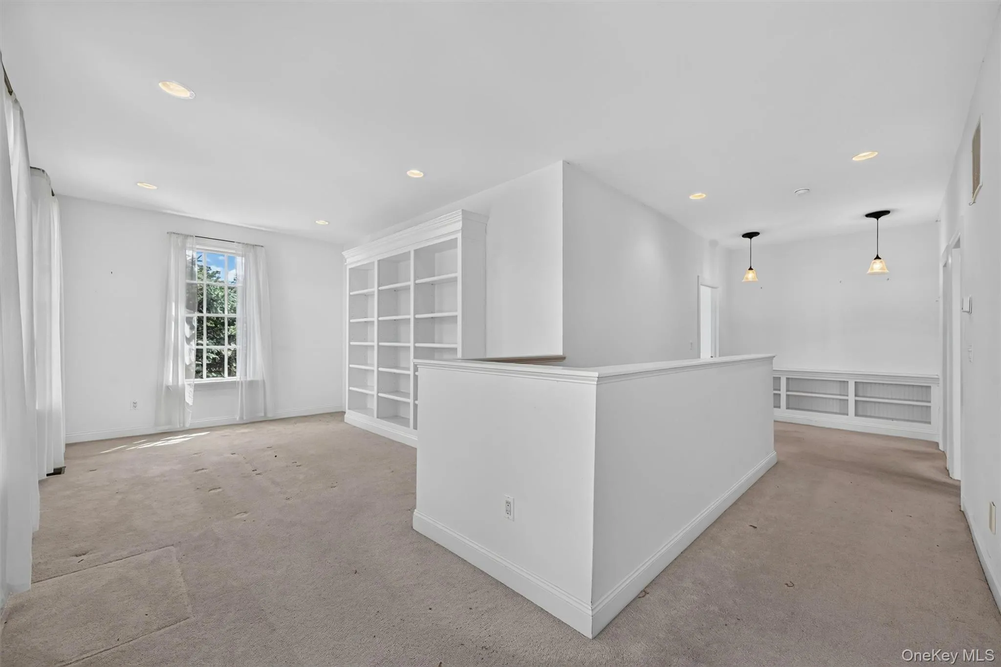 A spacious upstairs bonus area offers built-in shelving and room for a reading nook, office, craft space, or sitting area. A spacious upstairs bonus area offers built-in shelving and room for a reading nook, office, craft space, or sitting area.
