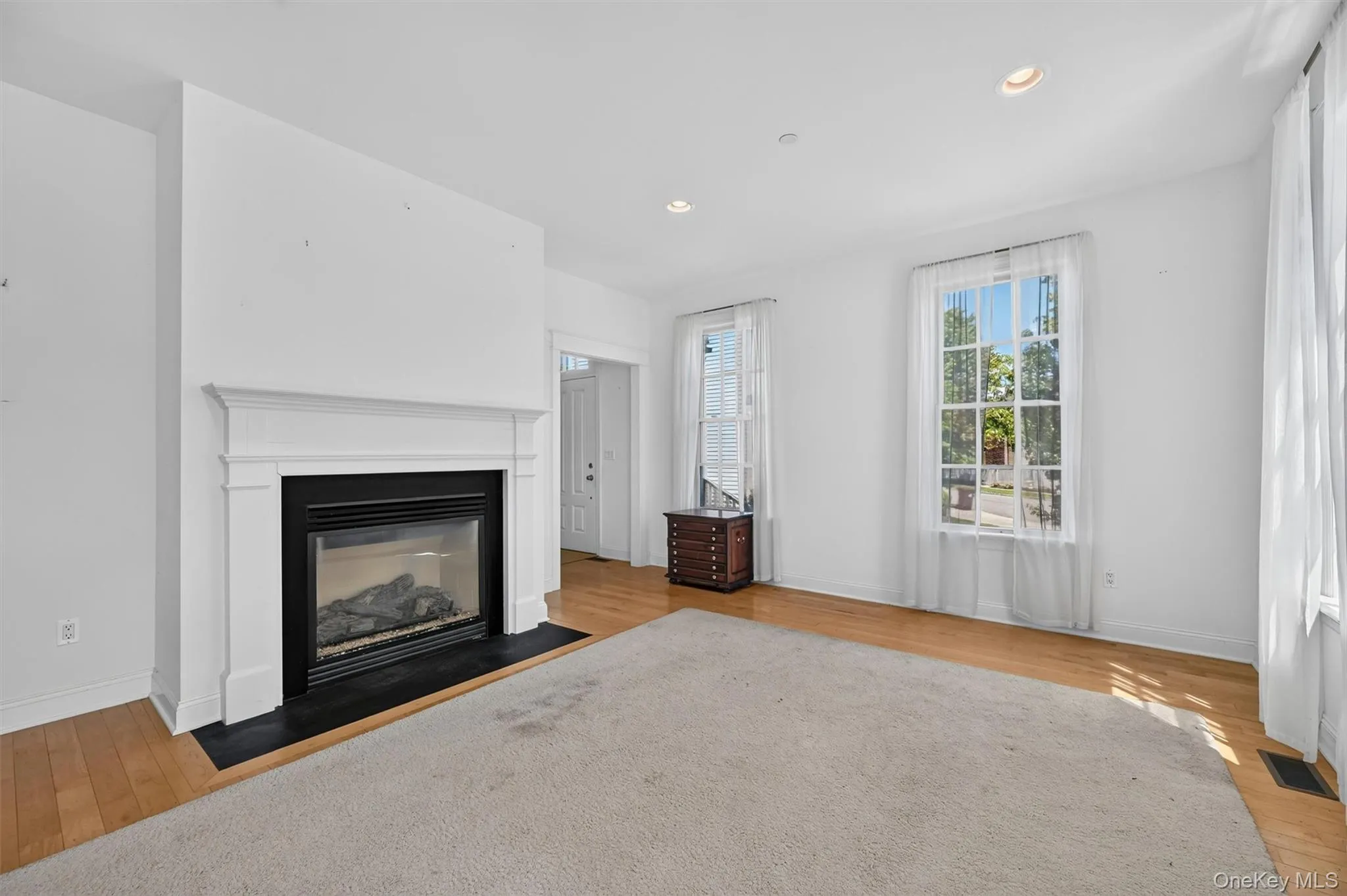 Tall ceilings, large windows, and a gas fireplace create a bright and inviting living area with plenty of room to relax. Tall ceilings, large windows, and a gas fireplace create a bright and inviting living area with plenty of room to relax.
