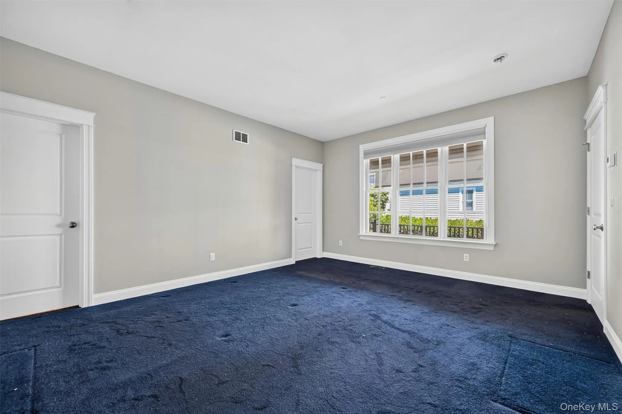 Another view of the primary suite highlights the room’s comfortable size, natural light, and peaceful connection to the covered porch. Another view of the primary suite highlights the room’s comfortable size, natural light, and peaceful connection to the covered porch.