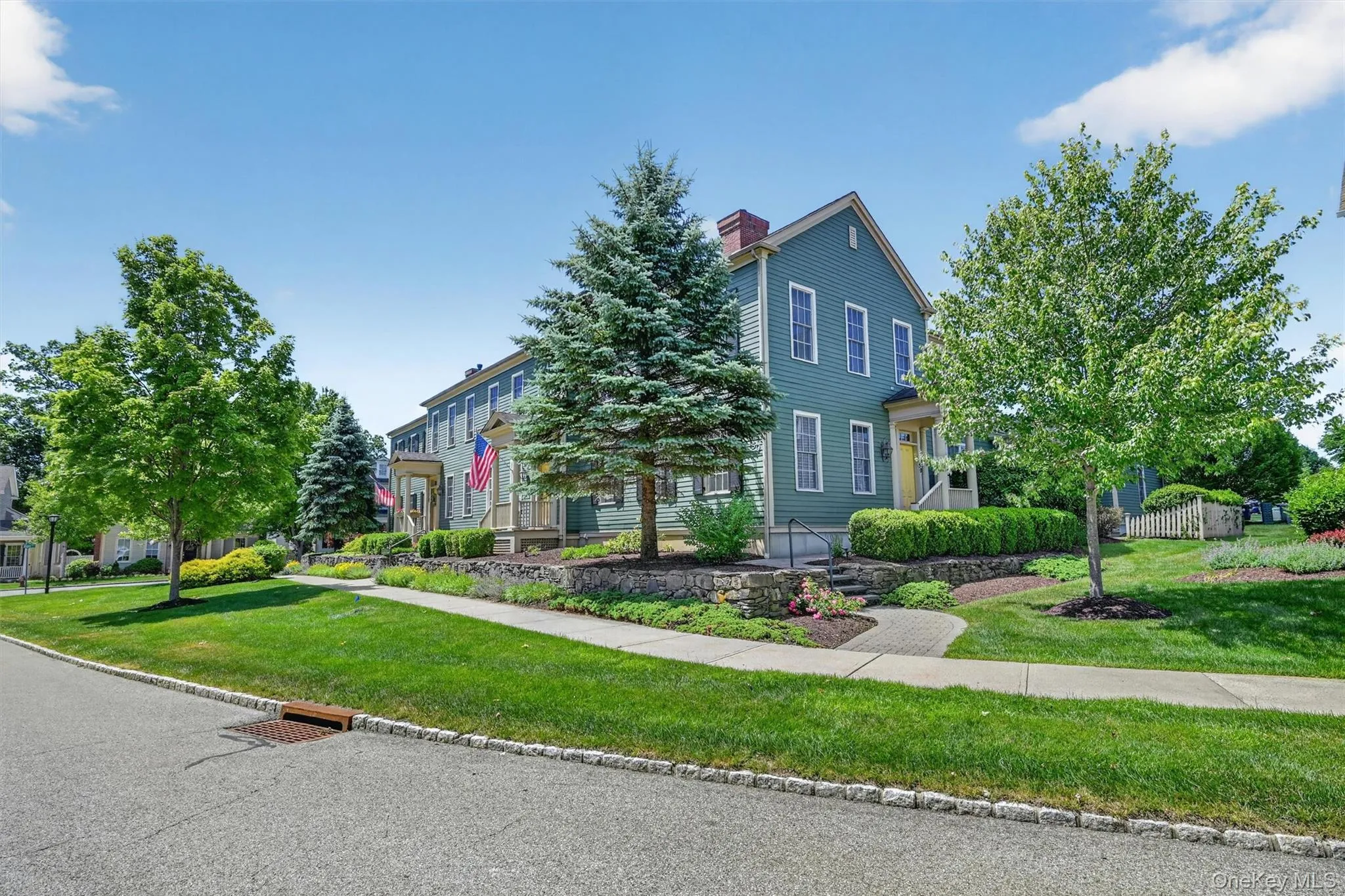 Beautiful landscaping, stone walls, and tree-lined sidewalks create a peaceful approach to the home. Beautiful landscaping, stone walls, and tree-lined sidewalks create a peaceful approach to the home.