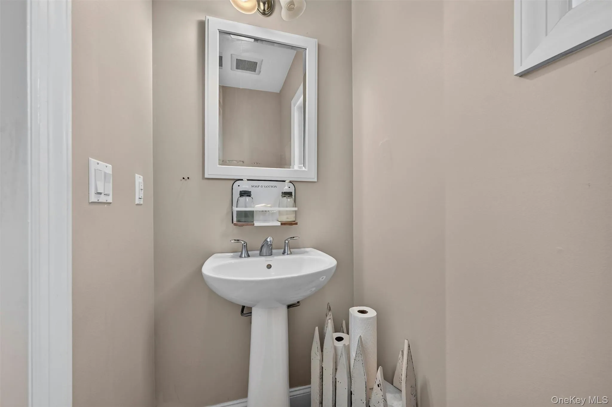 A convenient main-level half bath is tucked off the hallway for guests and everyday use. This completes the main level. A convenient main-level half bath is tucked off the hallway for guests and everyday use. This completes the main level.