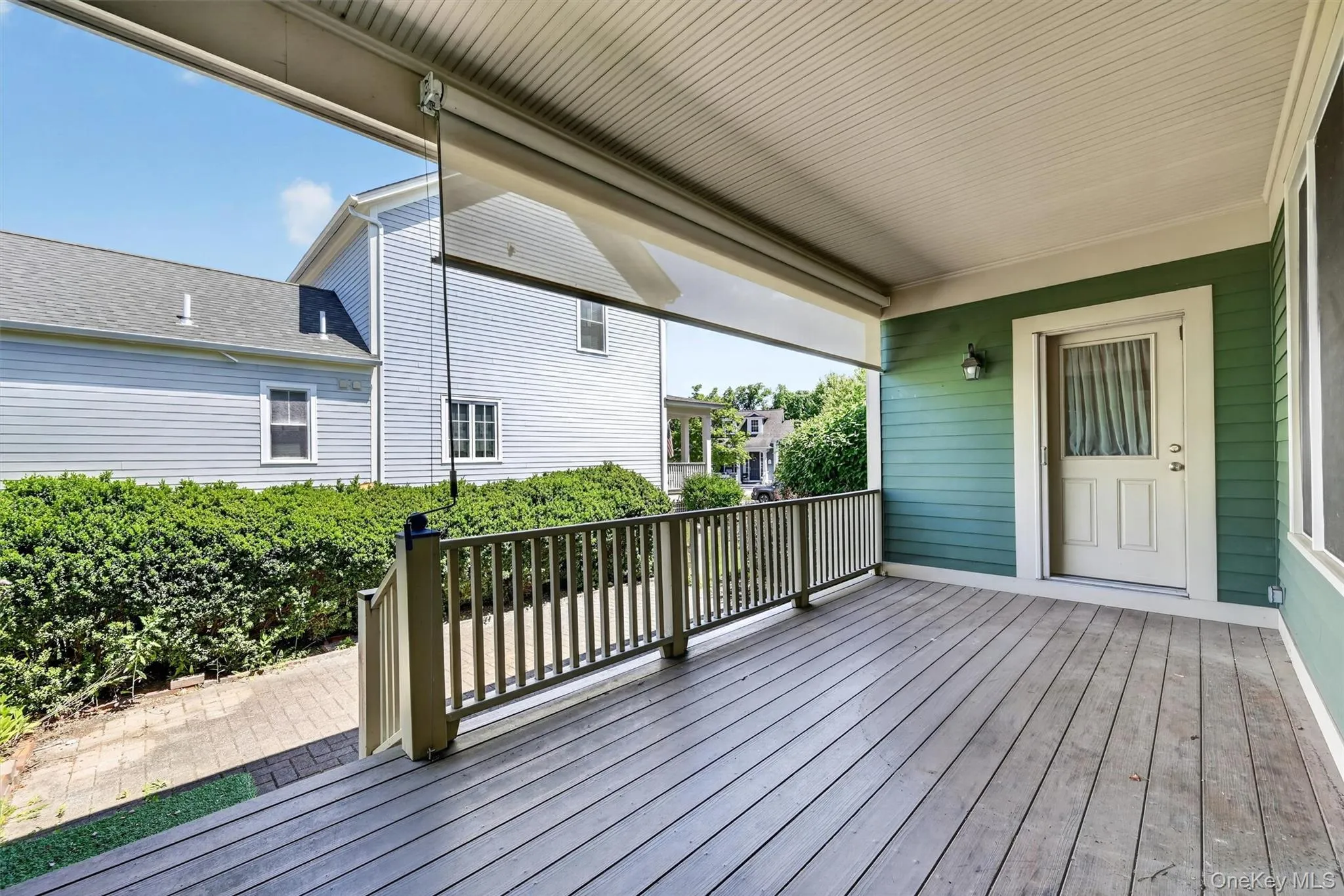 The covered porch doubles as a breezeway, creating a sheltered outdoor connection between the home and garage. The covered porch doubles as a breezeway, creating a sheltered outdoor connection between the home and garage.