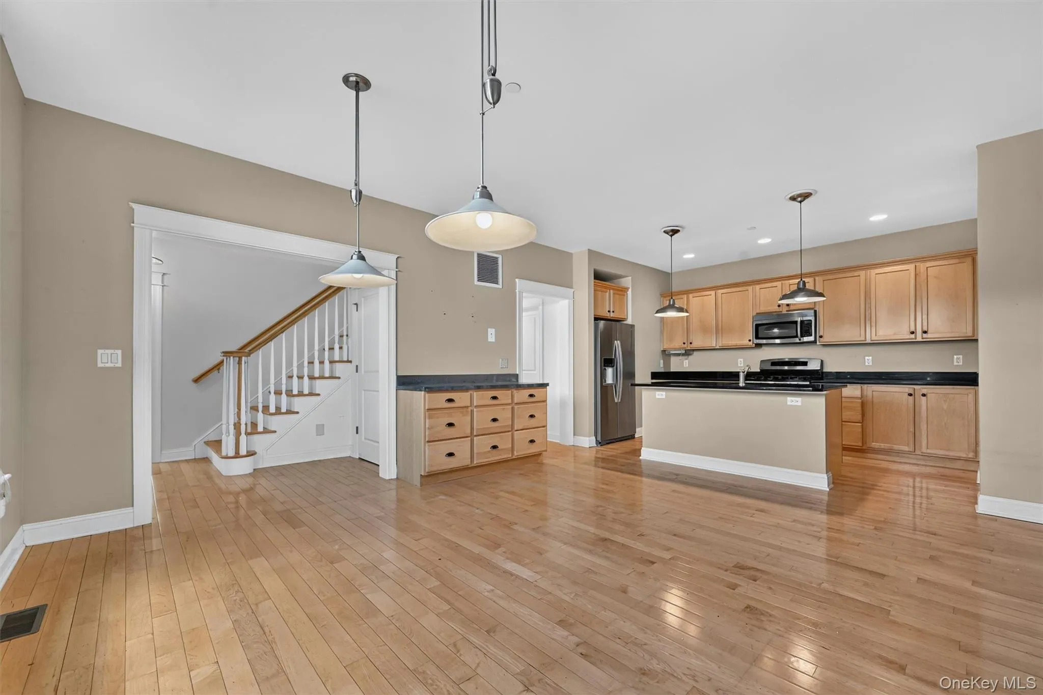 Hardwood floors, pendant lighting, and an open layout connect the kitchen beautifully with the rest of the main level. Hardwood floors, pendant lighting, and an open layout connect the kitchen beautifully with the rest of the main level.