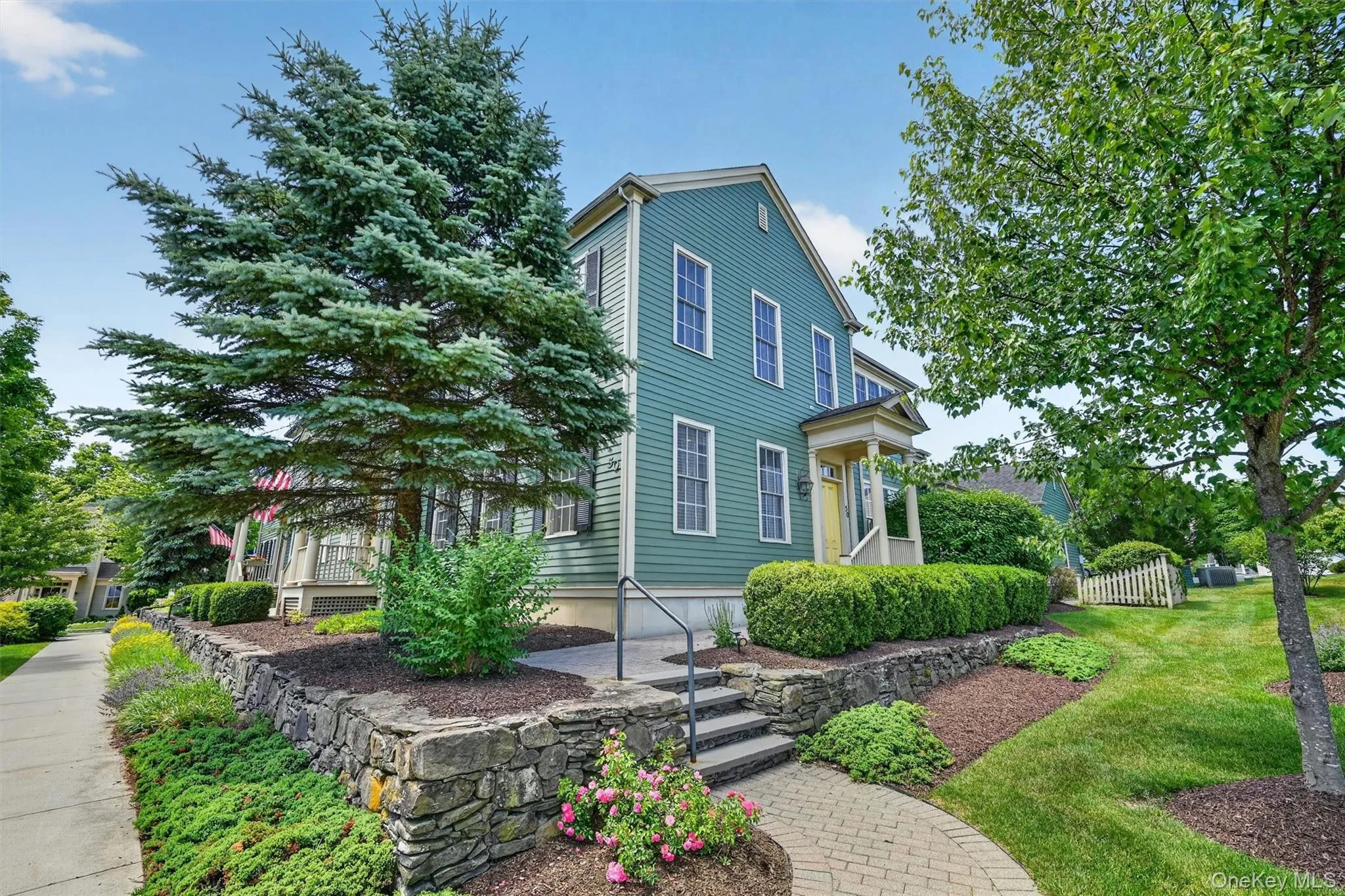 A closer look captures the home’s classic curb appeal, mature trees, stone garden walls, and peaceful surroundings. A closer look captures the home’s classic curb appeal, mature trees, stone garden walls, and peaceful surroundings.