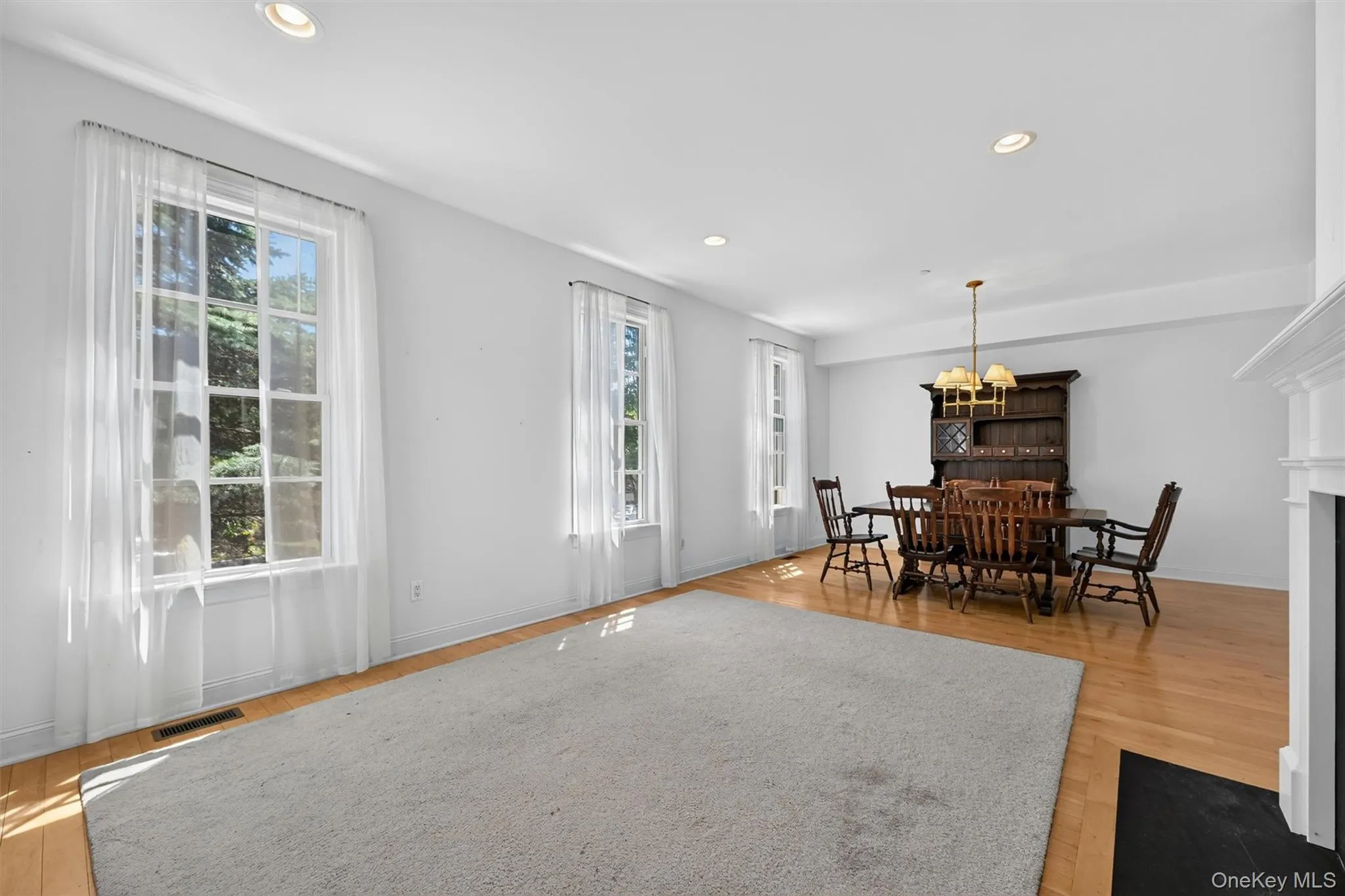 To the left of the entrance you will find the open living and dining area. Large windows fill the room with natural light, creating a spacious setting for everyday living and gathering. To the left of the entrance you will find the open living and dining area. Large windows fill the room with natural light, creating a spacious setting for everyday living and gathering.