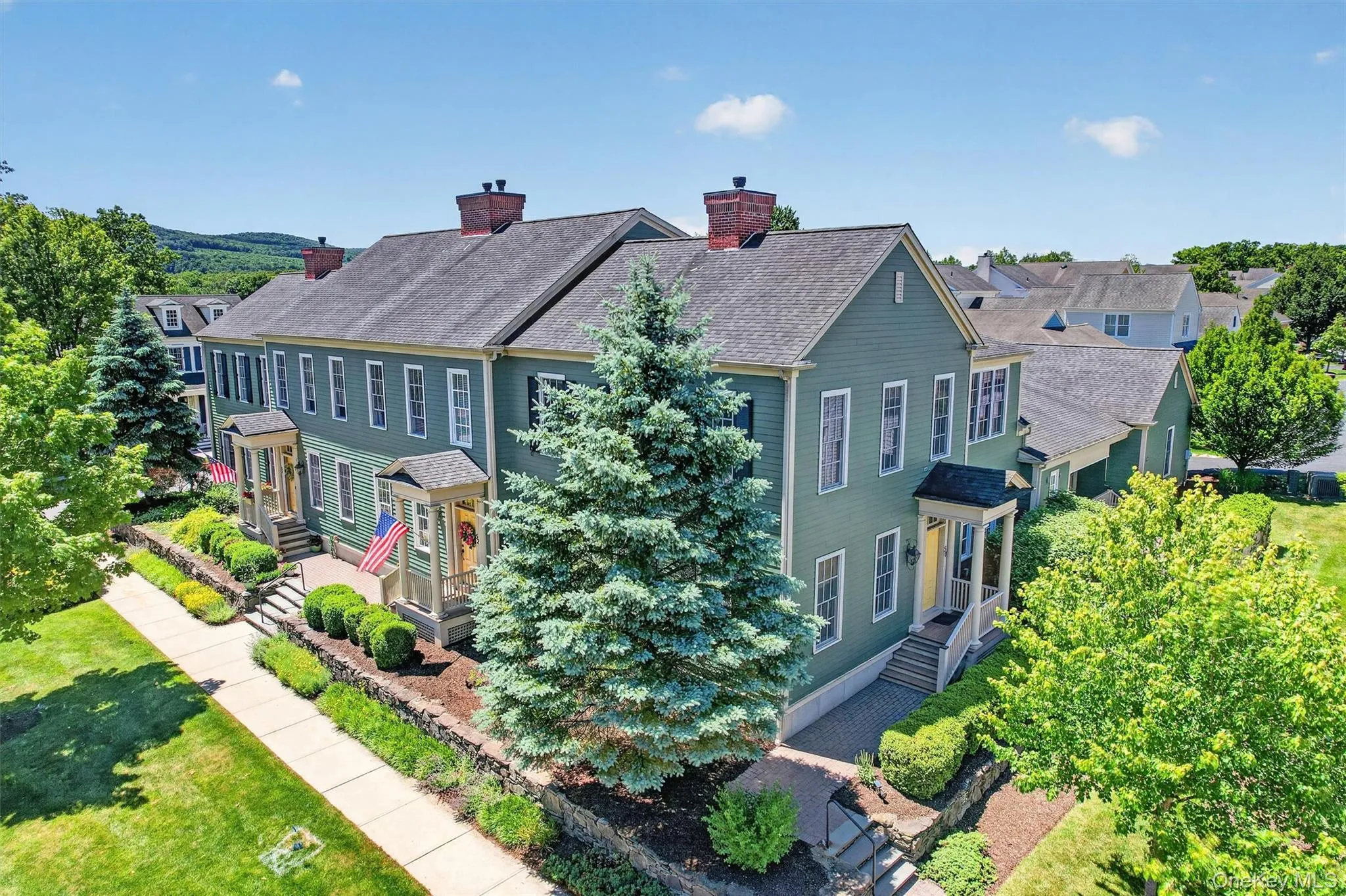 An elevated view showcases the charming landscape, manicured grounds, and thoughtfully designed setting that gives the Warwick Grove community its inviting neighborhood feel. An elevated view showcases the charming landscape, manicured grounds, and thoughtfully designed setting that gives the Warwick Grove community its inviting neighborhood feel.