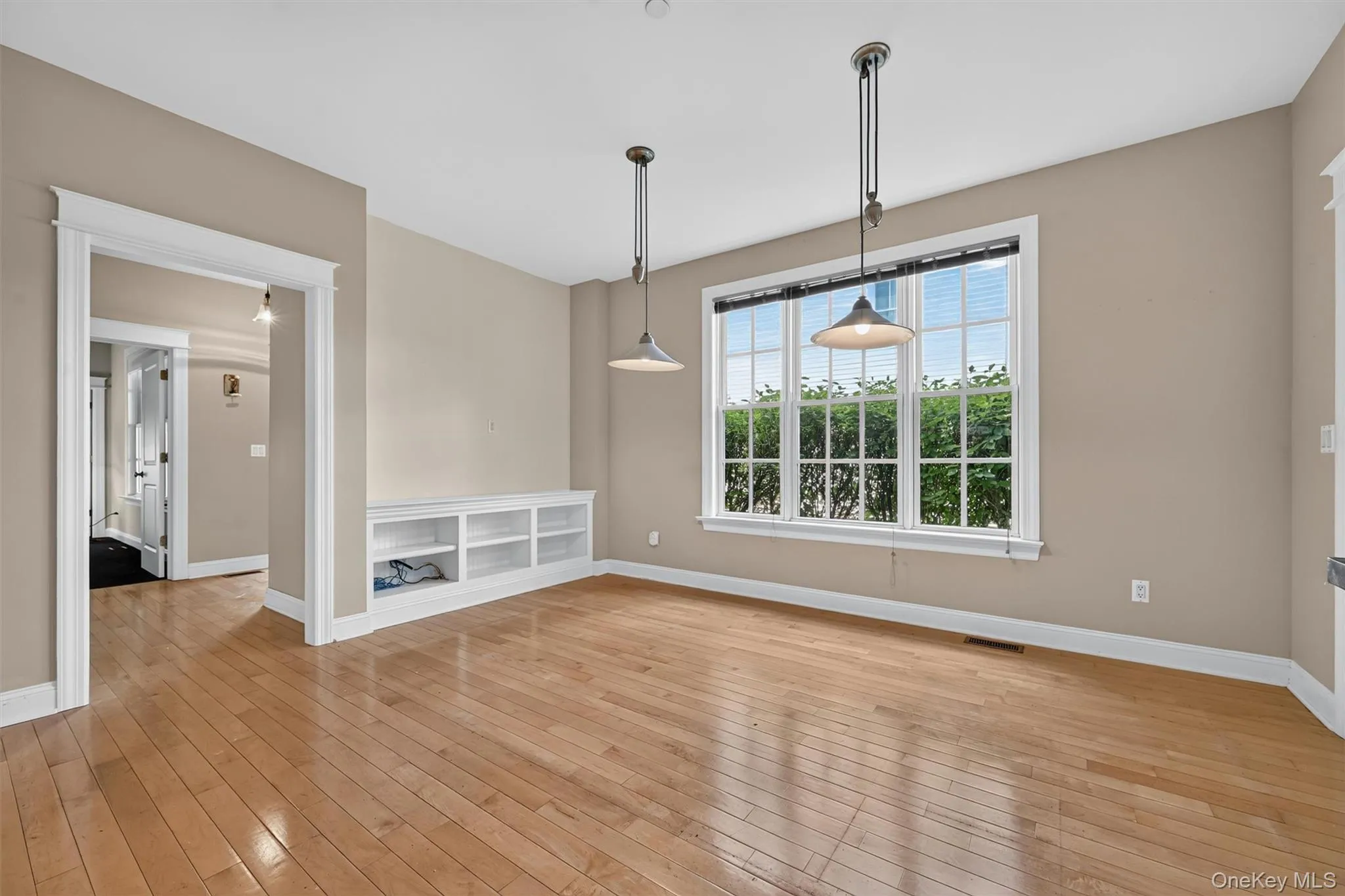 As you pass through the kitchen, a small hallway connects the primary suite, lavatory, and back entrance from the covered garage breezeway. As you pass through the kitchen, a small hallway connects the primary suite, lavatory, and back entrance from the covered garage breezeway.