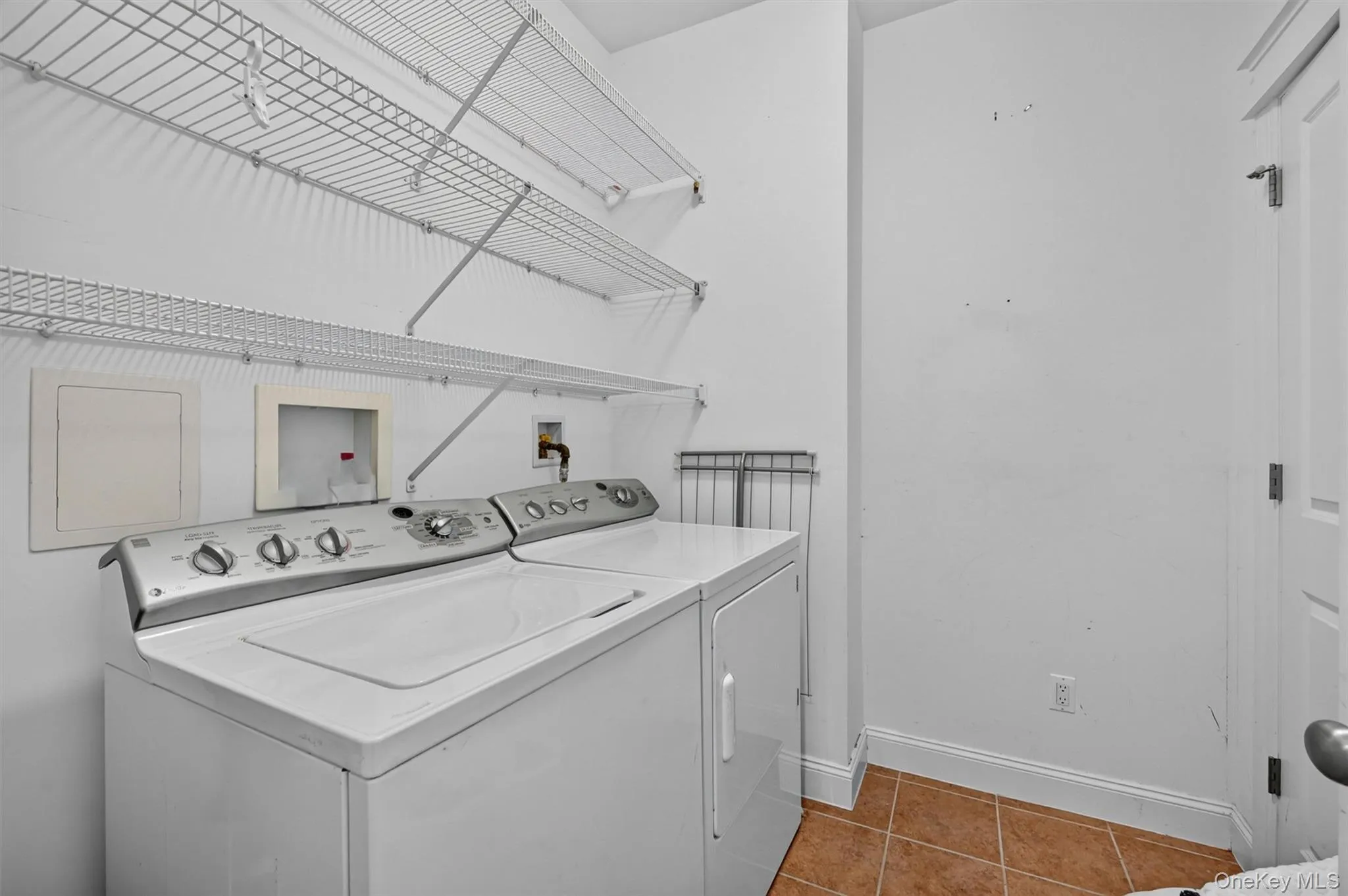 The main-level laundry room adds everyday convenience with shelving and a closet for household storage. The main-level laundry room adds everyday convenience with shelving and a closet for household storage.
