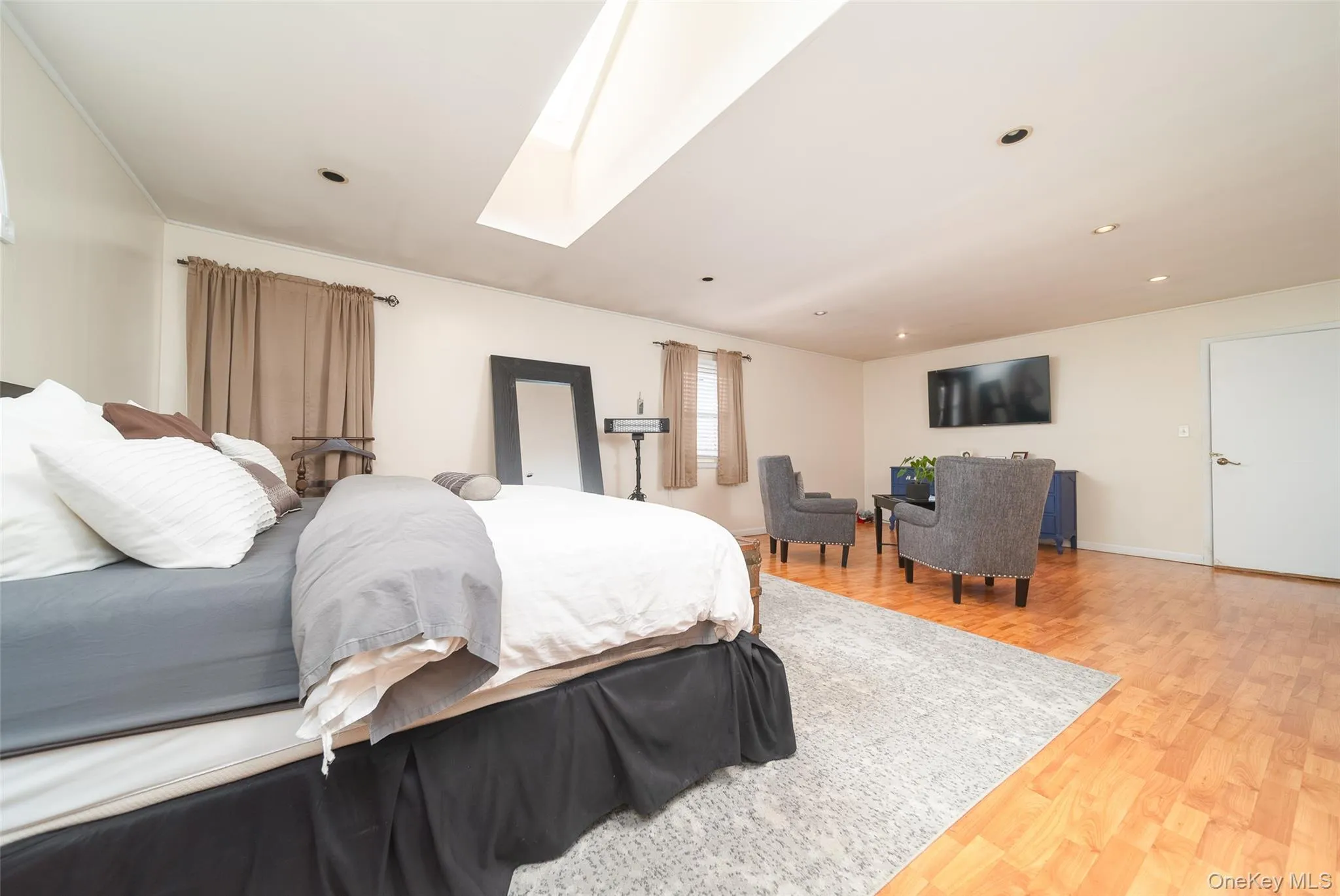 Bedroom with a skylight and light wood-type flooring Bedroom with a skylight and light wood-type flooring