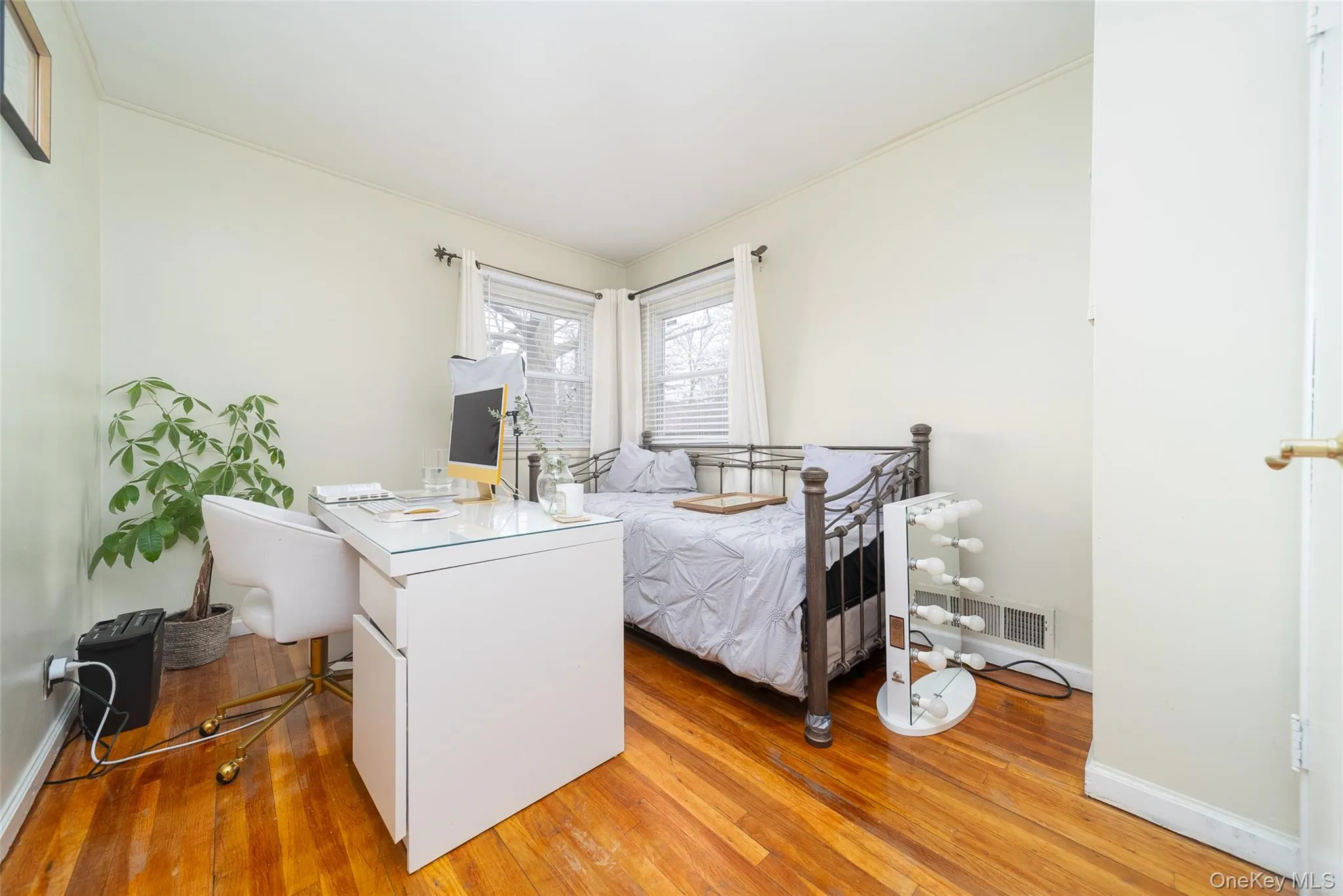 Bedroom with light wood-type flooring and a desk Bedroom with light wood-type flooring and a desk
