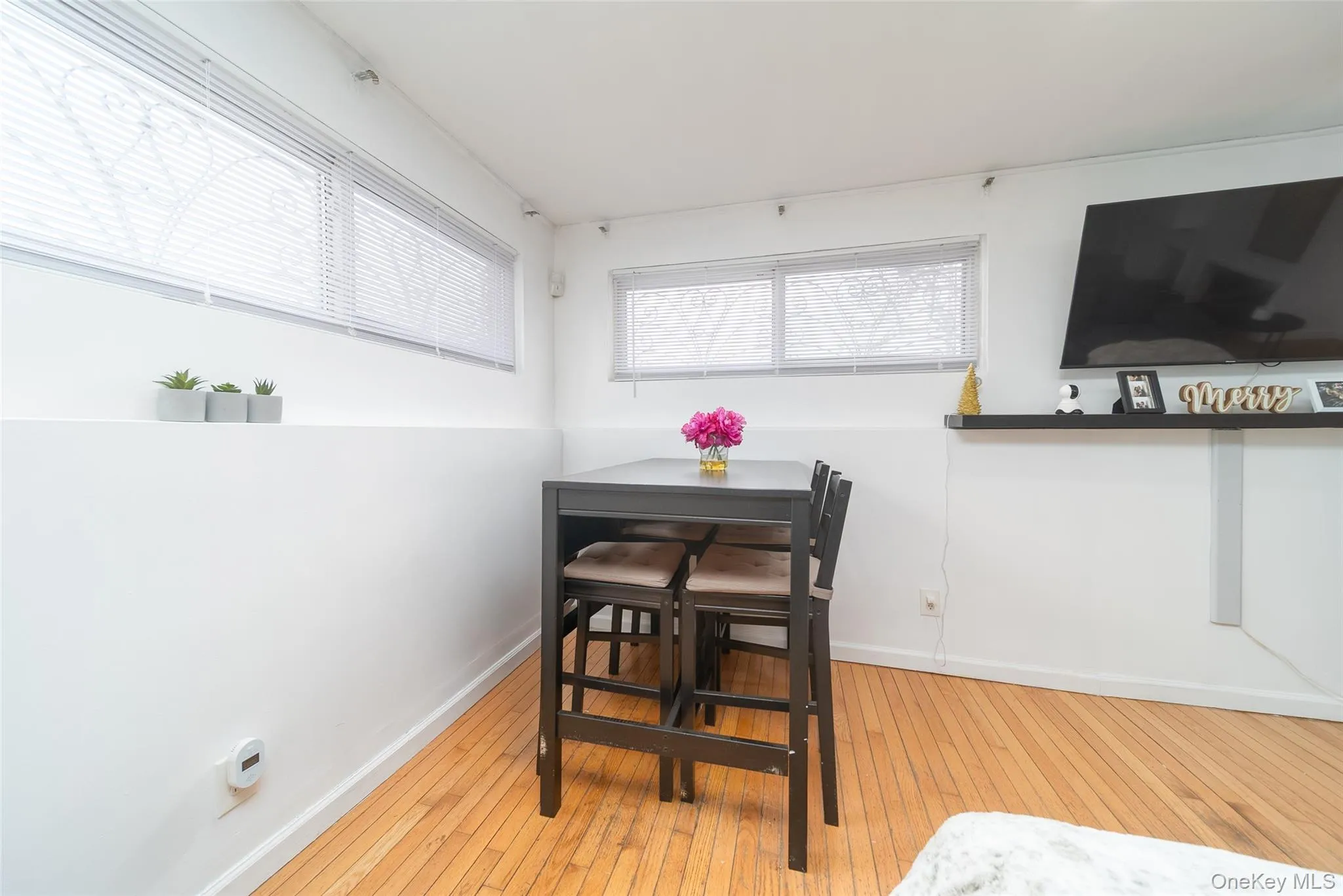 Dining space with light wood-style floors and baseboards Dining space with light wood-style floors and baseboards