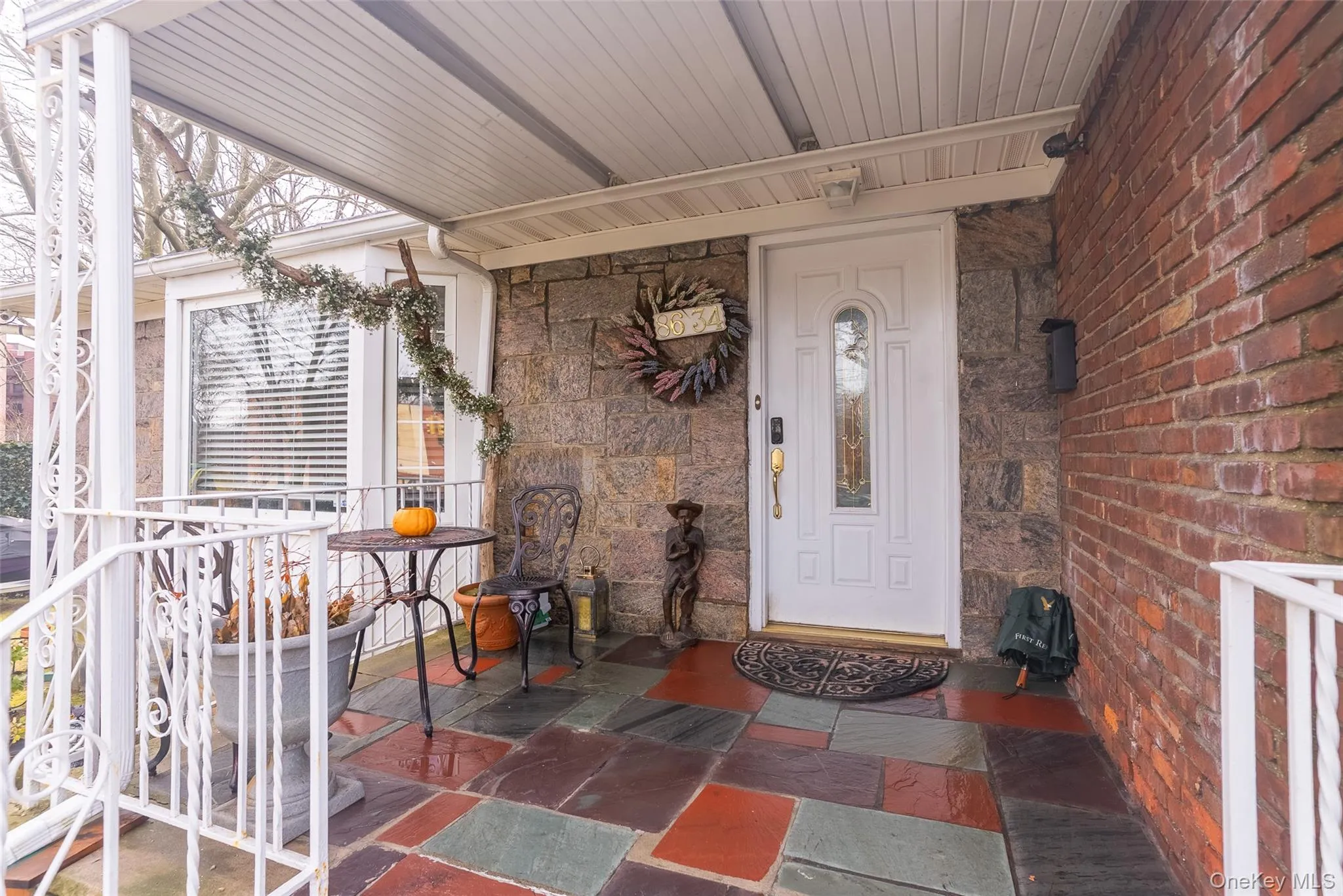 Entrance to property with stone siding and covered porch Entrance to property with stone siding and covered porch
