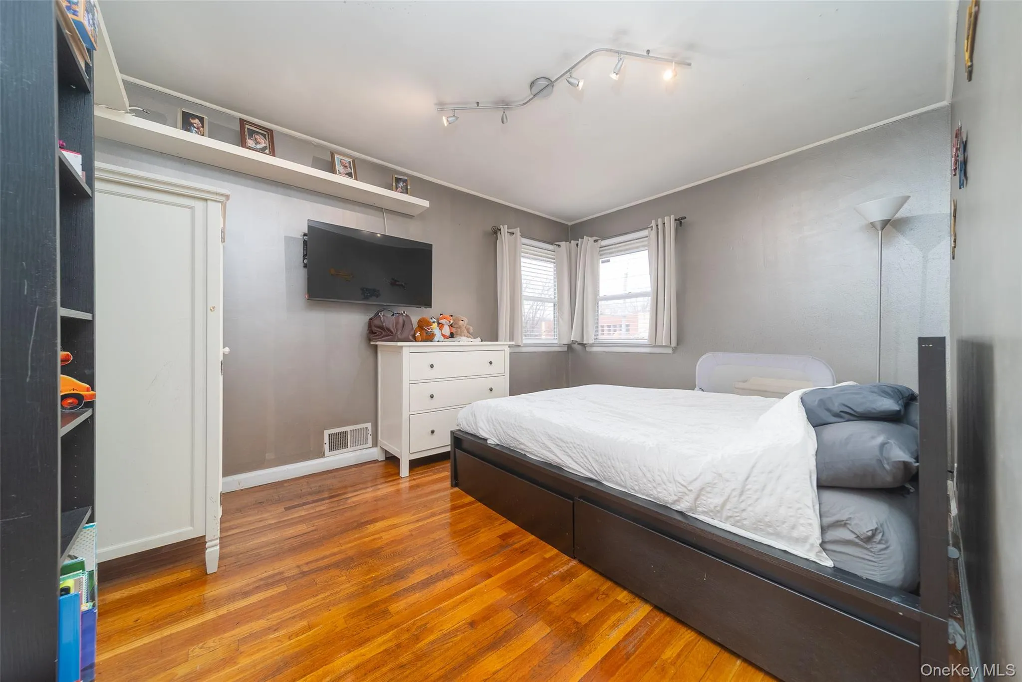 Bedroom with baseboards and wood finished floors Bedroom with baseboards and wood finished floors