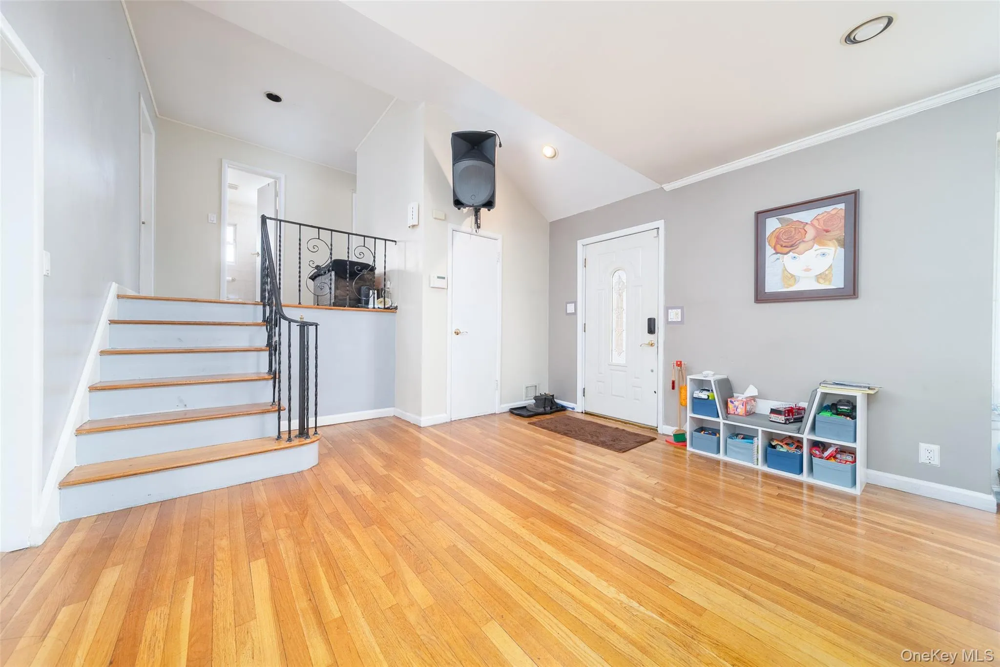 Foyer featuring light wood-style floors and lofted ceiling Foyer featuring light wood-style floors and lofted ceiling