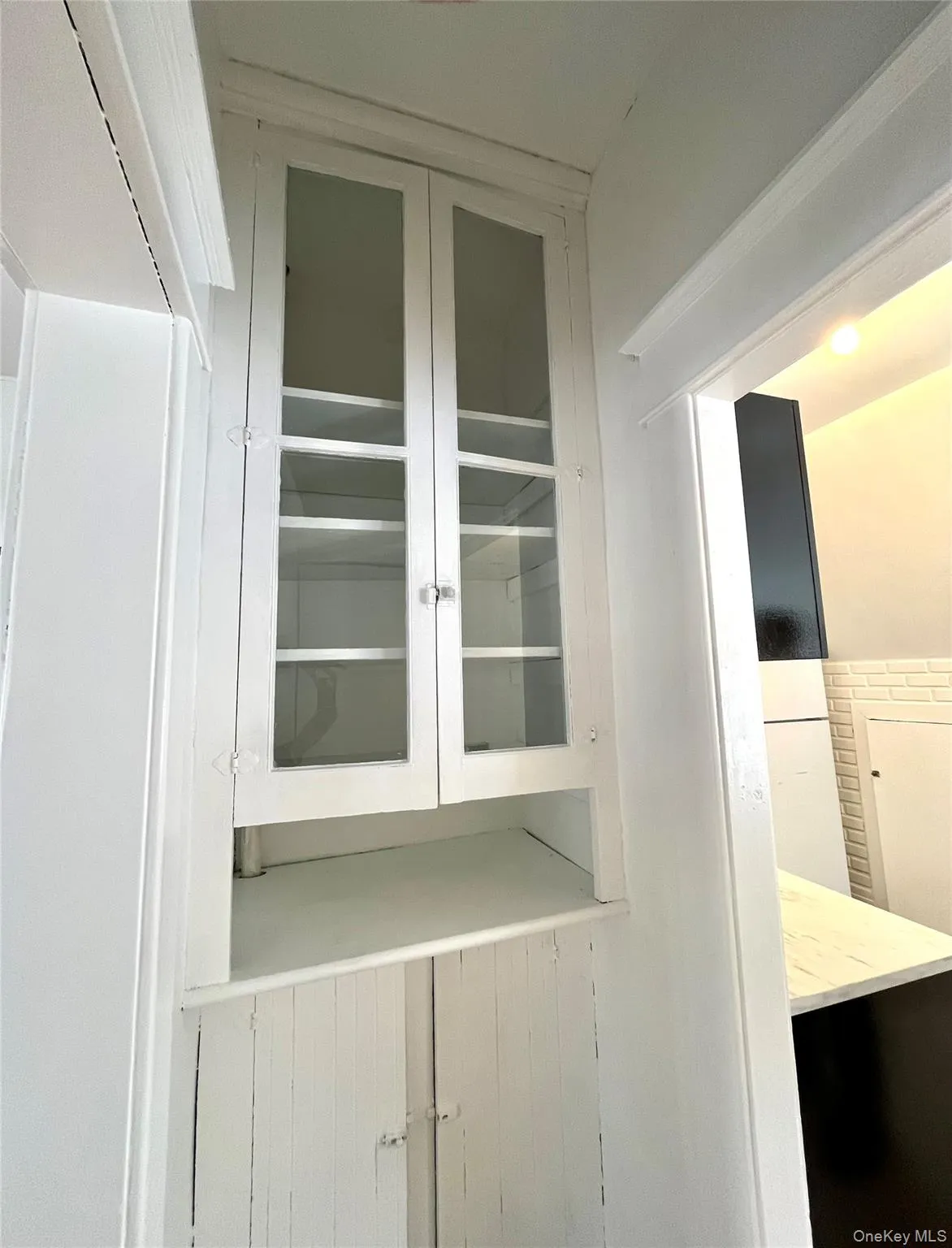 Detailed view of glass front cabinets just off the kitchen Detailed view of glass front cabinets just off the kitchen