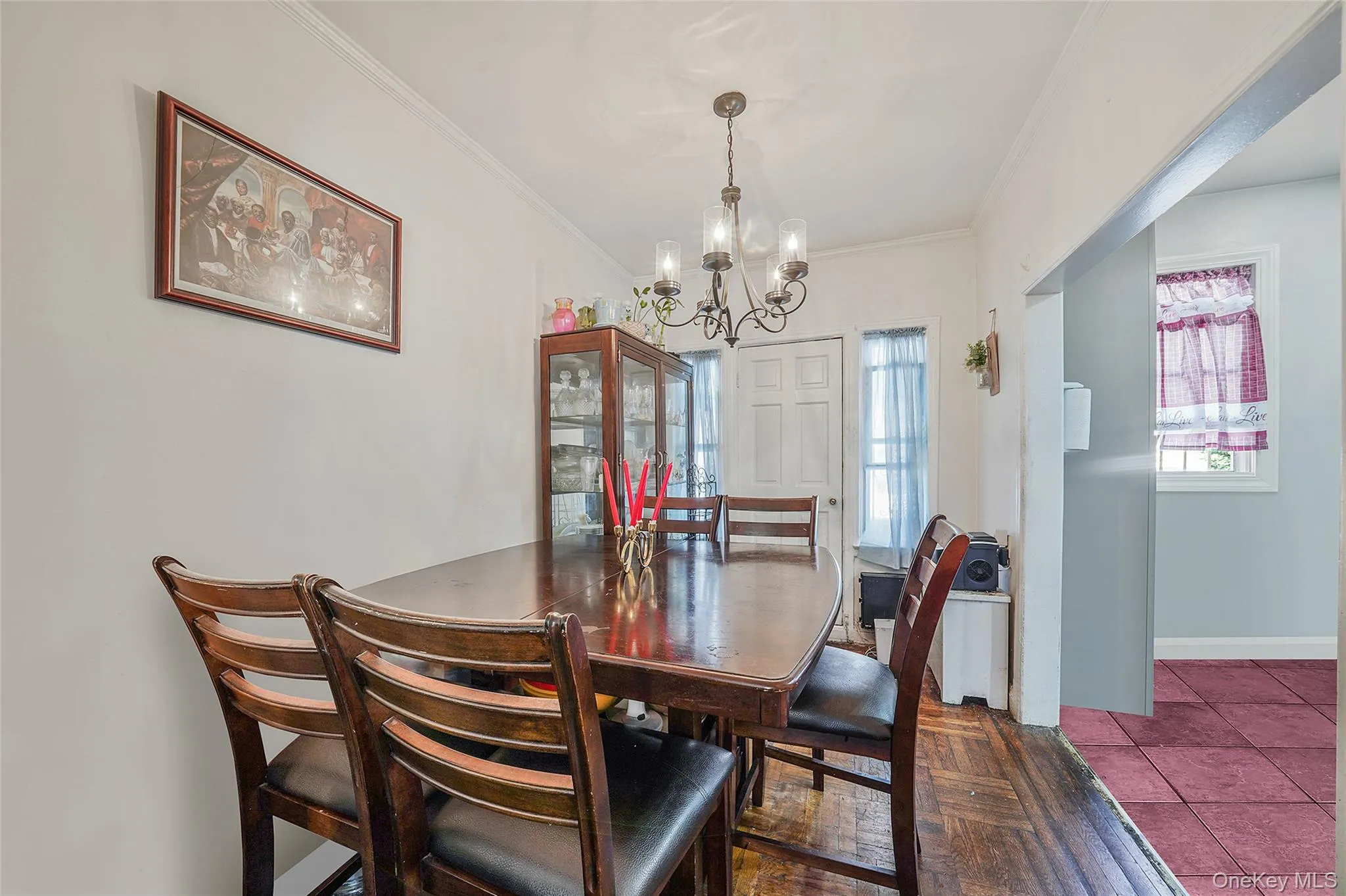 Dining space with a chandelier and ornamental molding Dining space with a chandelier and ornamental molding