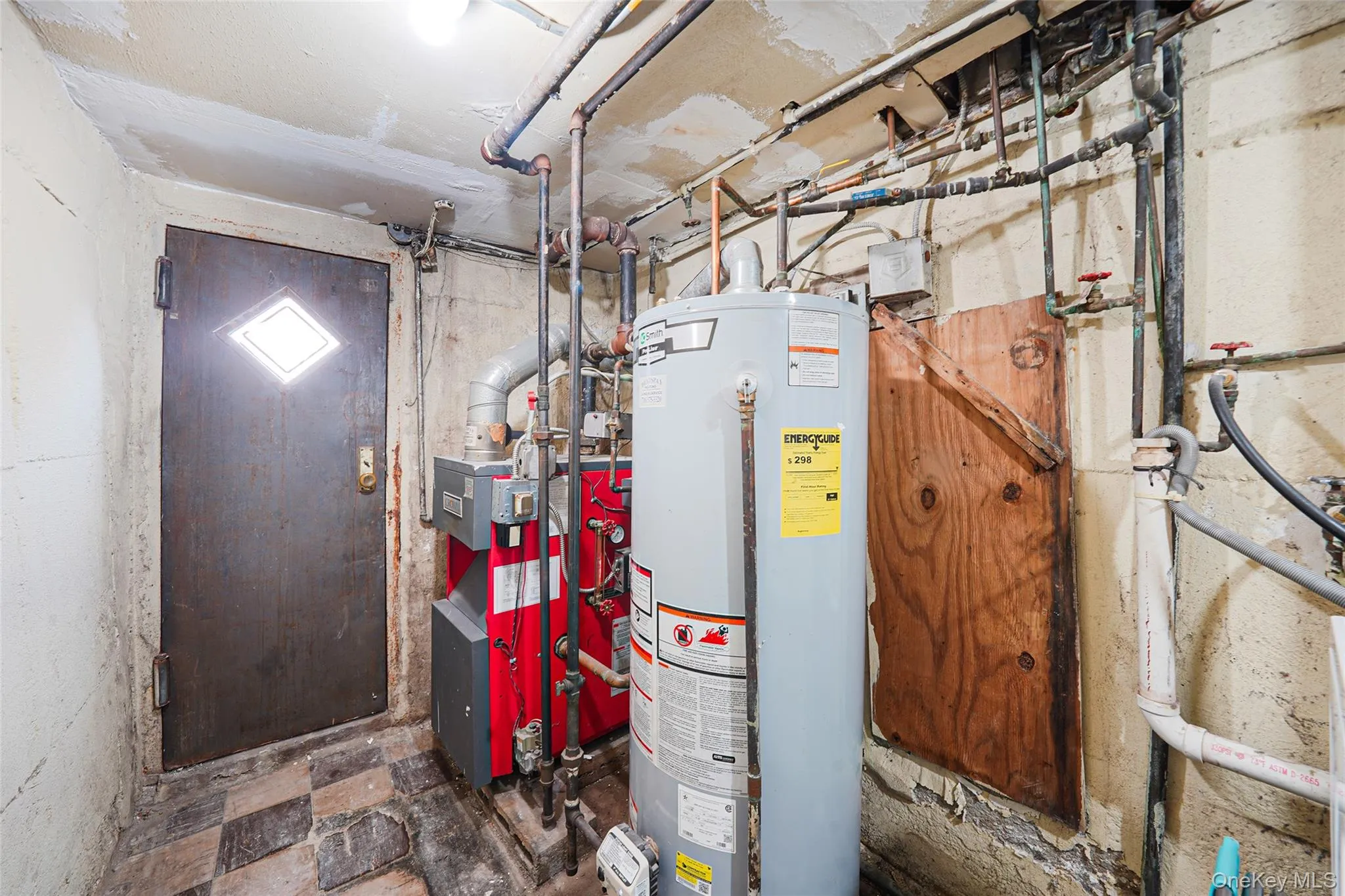 Utility room featuring water heater and a heating unit Utility room featuring water heater and a heating unit
