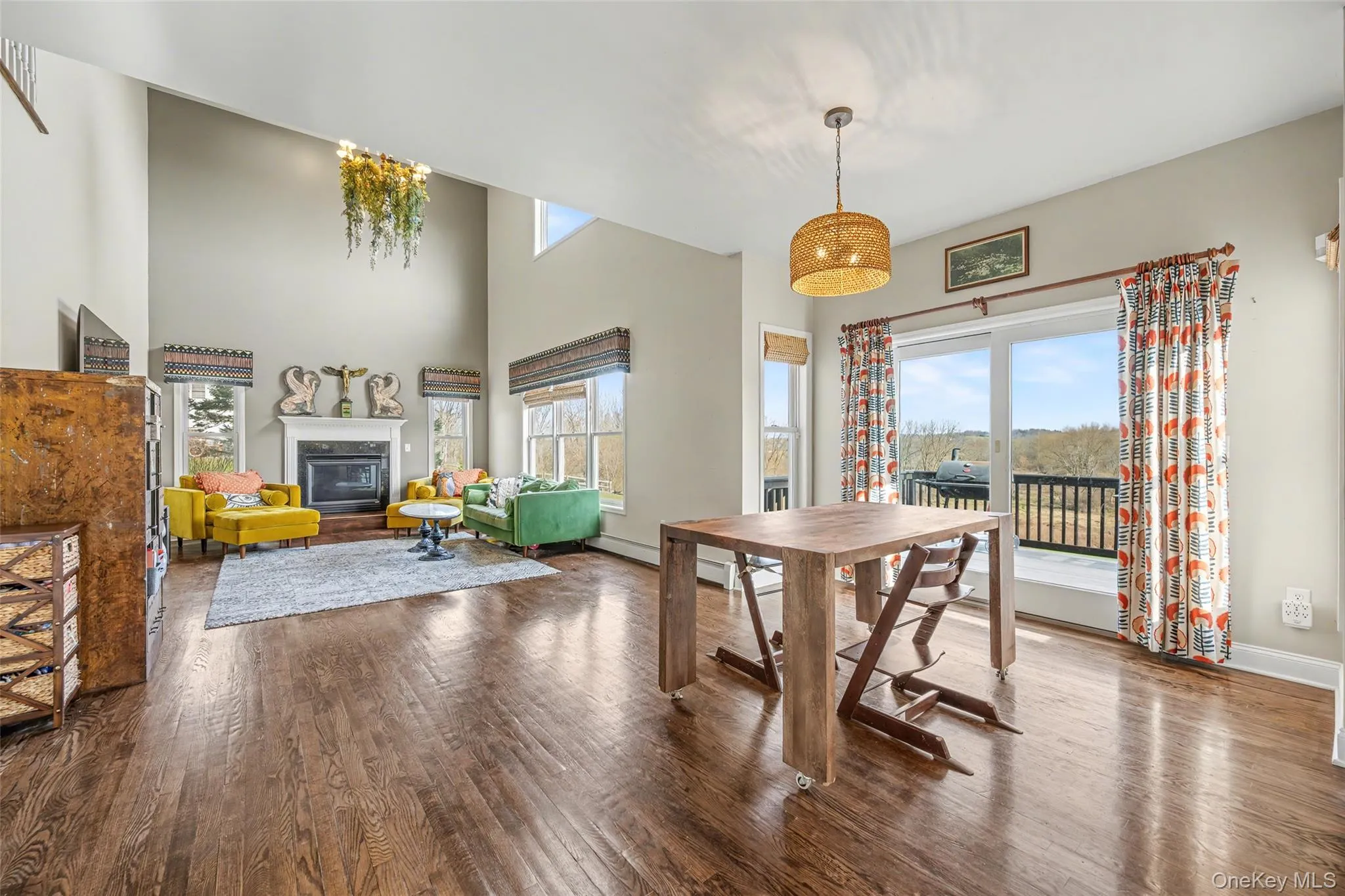 Expansive great room with soaring ceilings, oversized windows, and direct access to the rear deck, perfect for everyday living and effortless entertaining. Expansive great room with soaring ceilings, oversized windows, and direct access to the rear deck, perfect for everyday living and effortless entertaining.