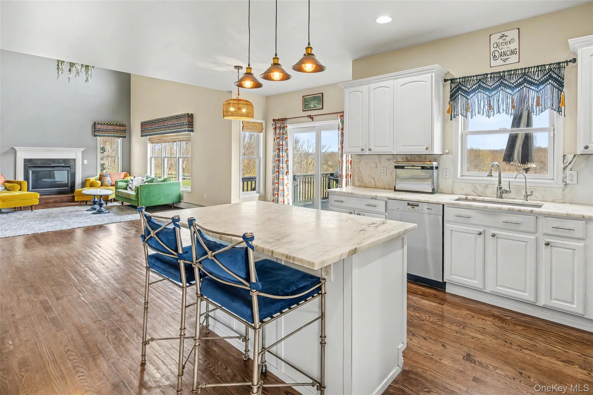 Open kitchen with marble countertops and island seating, perfectly positioned to overlook the great room and capture natural light throughout. Open kitchen with marble countertops and island seating, perfectly positioned to overlook the great room and capture natural light throughout.