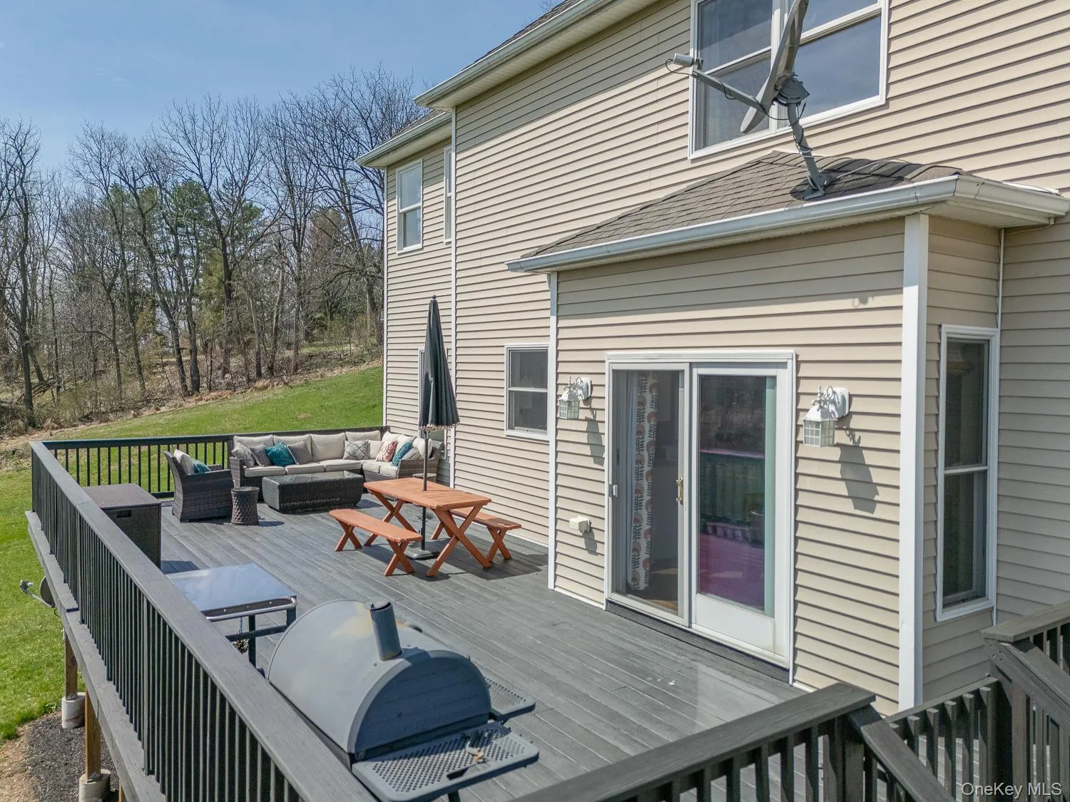 Spacious rear deck designed for outdoor living, offering ample room for dining, lounging, and entertaining. Spacious rear deck designed for outdoor living, offering ample room for dining, lounging, and entertaining.