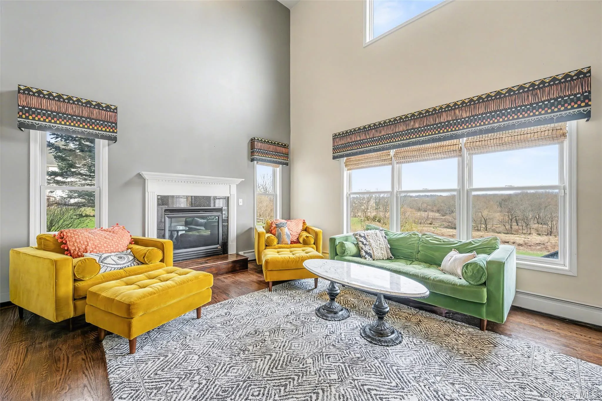 Sunlit living area framed by large windows that capture peaceful views of the surrounding landscape. Sunlit living area framed by large windows that capture peaceful views of the surrounding landscape.