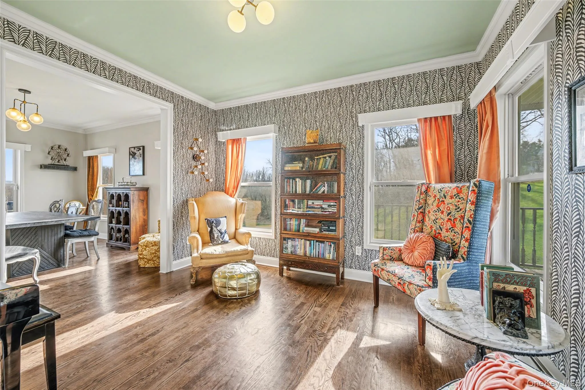 Inviting main-level living room/study offering flexibility for work or relaxation, with large windows and a warm, character-filled design. Inviting main-level living room/study offering flexibility for work or relaxation, with large windows and a warm, character-filled design.