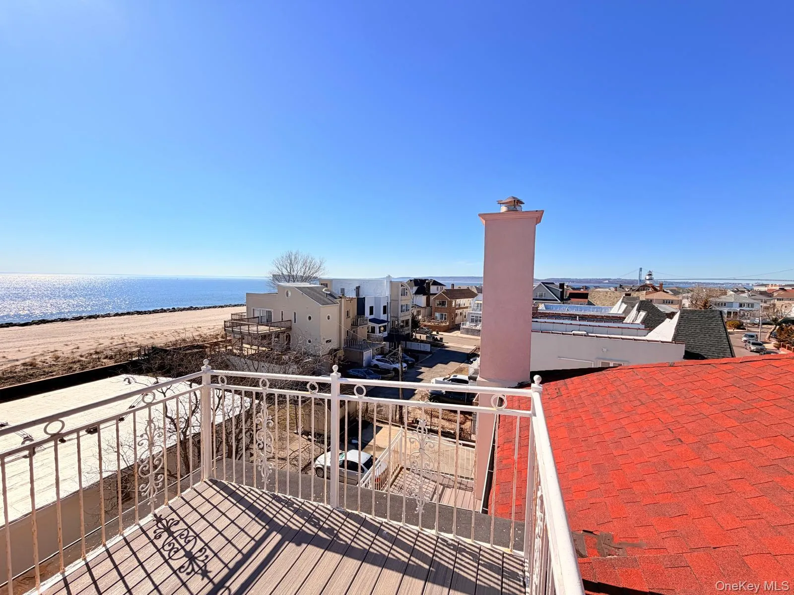 Wooden terrace featuring a water view and a residential view Wooden terrace featuring a water view and a residential view