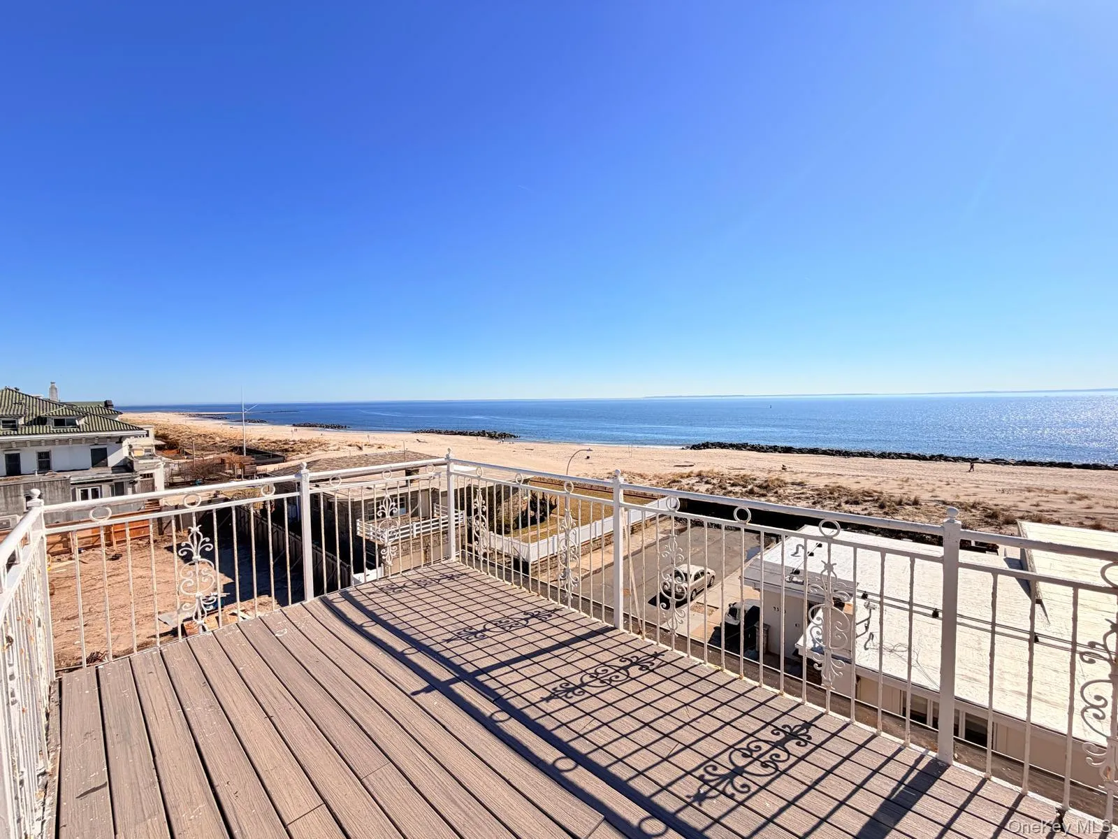 Deck with view of water and beach Deck with view of water and beach