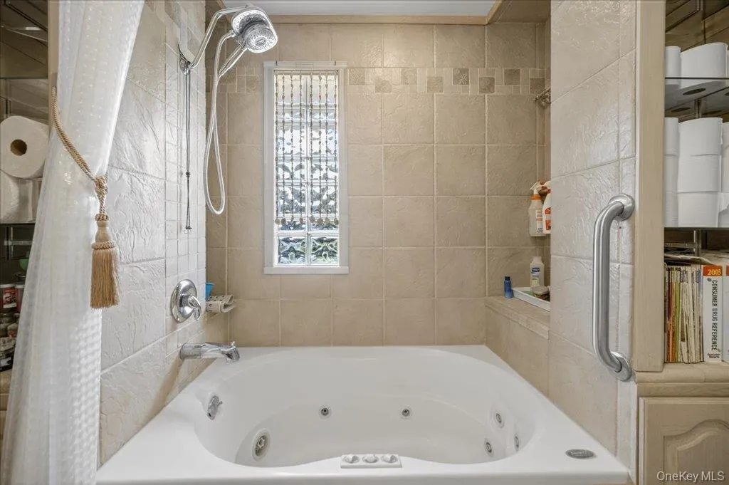 Full bathroom featuring a combined bath / shower with jetted tub Full bathroom featuring a combined bath / shower with jetted tub