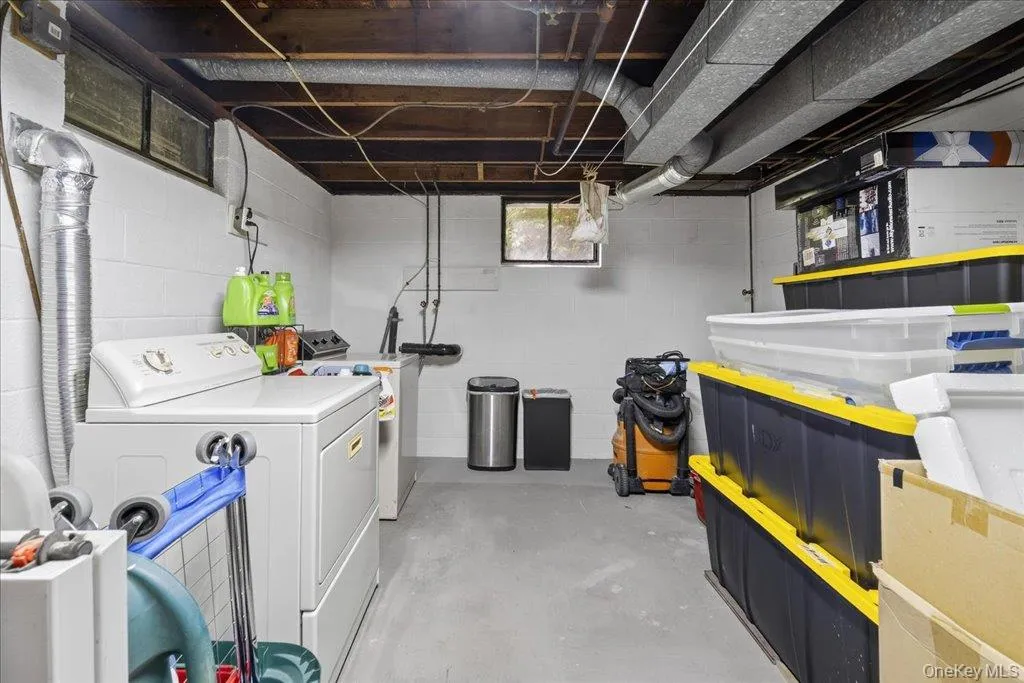 Below grade area with washing machine and clothes dryer Below grade area with washing machine and clothes dryer
