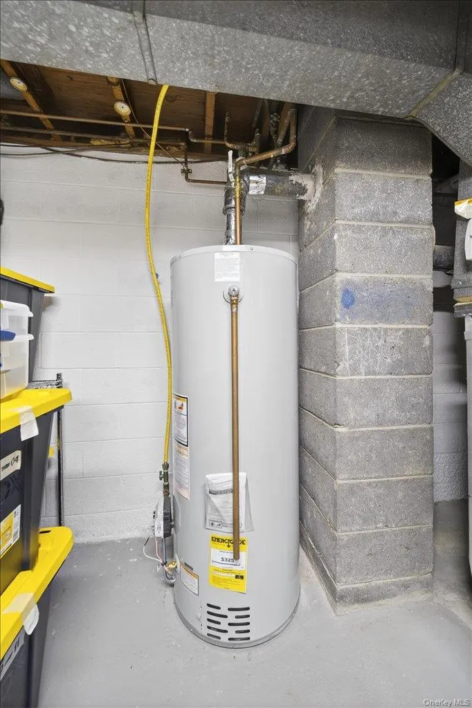Utility room featuring water heater Utility room featuring water heater