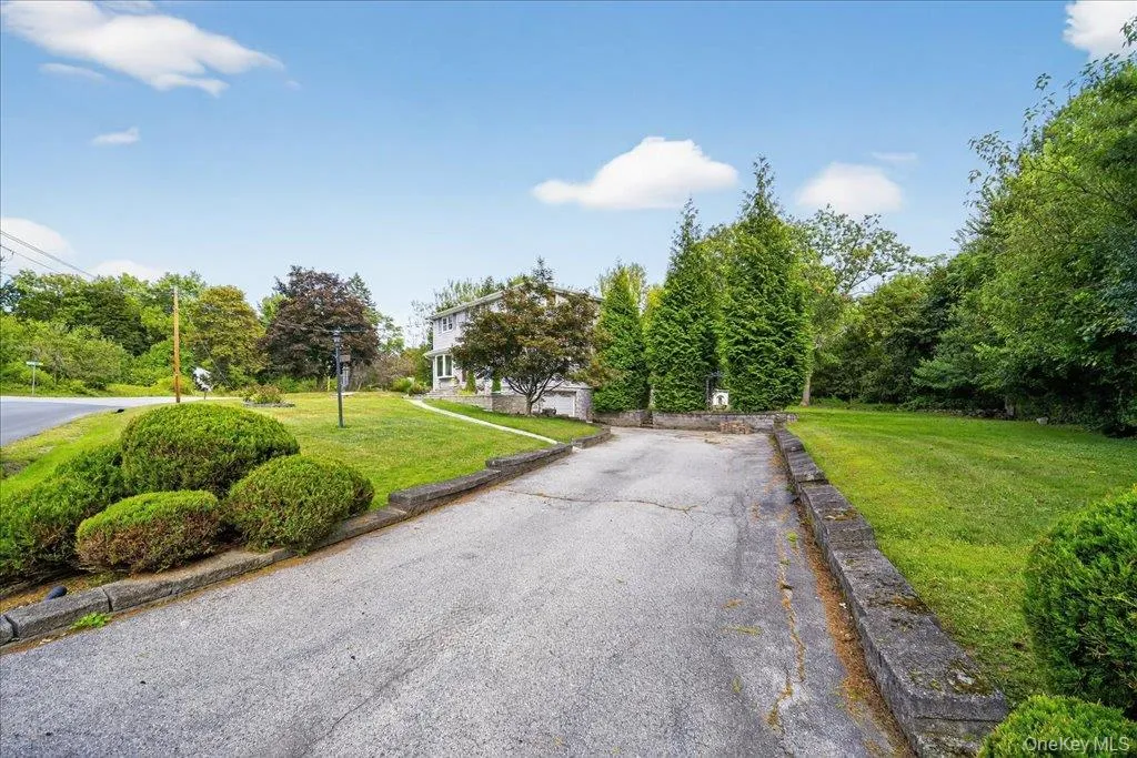 View of asphalt driveway with view of wooded area View of asphalt driveway with view of wooded area