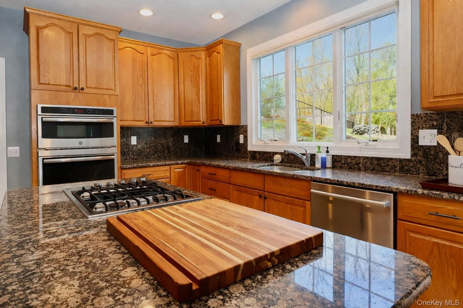 Windowed kitchen with beautiful views of the private backyard. Gas stove top and double oven. Windowed kitchen with beautiful views of the private backyard. Gas stove top and double oven.