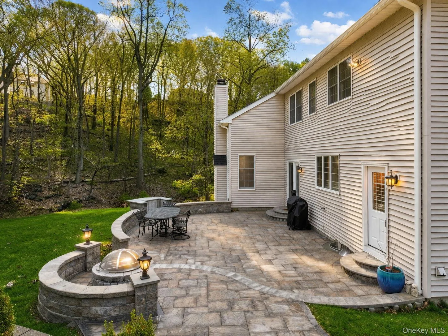 Stone-paved patio with designated space fora fire-pit and grill. Stone-paved patio with designated space fora fire-pit and grill.