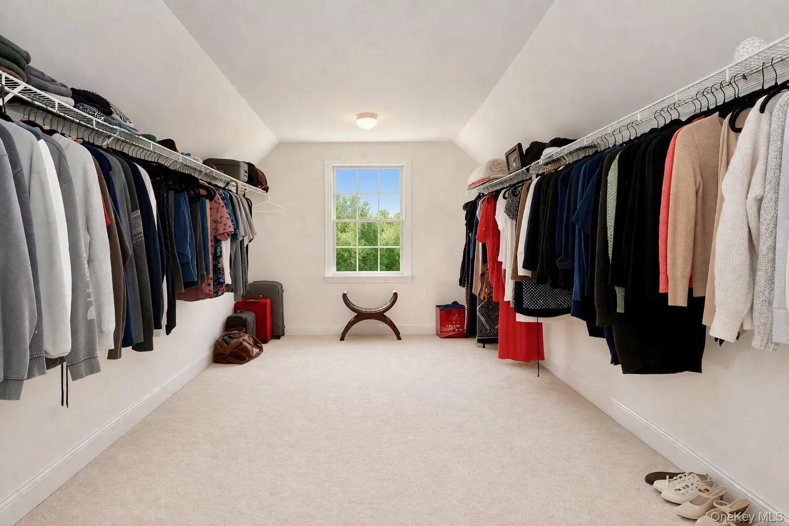 Primary bedroom walk in closet. Primary bedroom walk in closet.