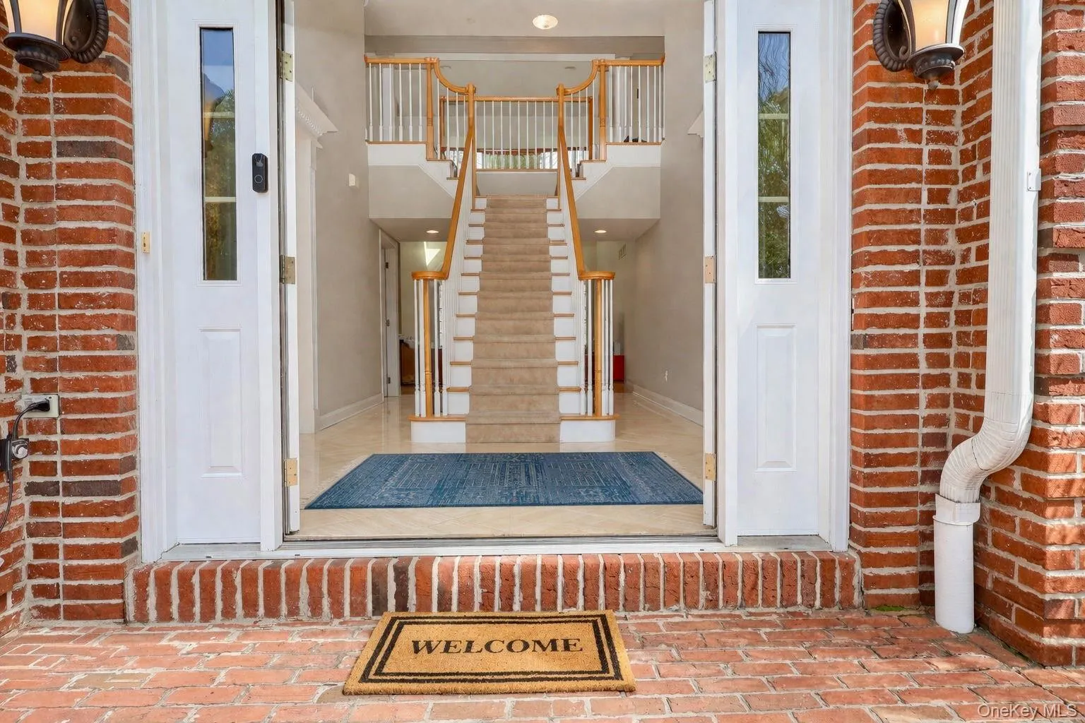 Double-door entrabce to foyer with grand staircase. Double-door entrabce to foyer with grand staircase.
