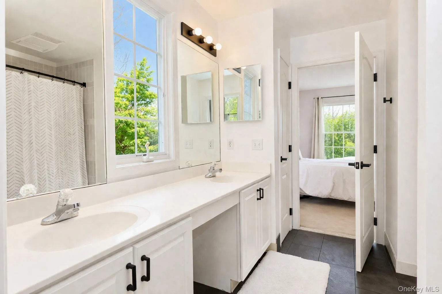 Jack and Jill bathroom with double vanity, makeup vanity area, and full bathtub. Jack and Jill bathroom with double vanity, makeup vanity area, and full bathtub.