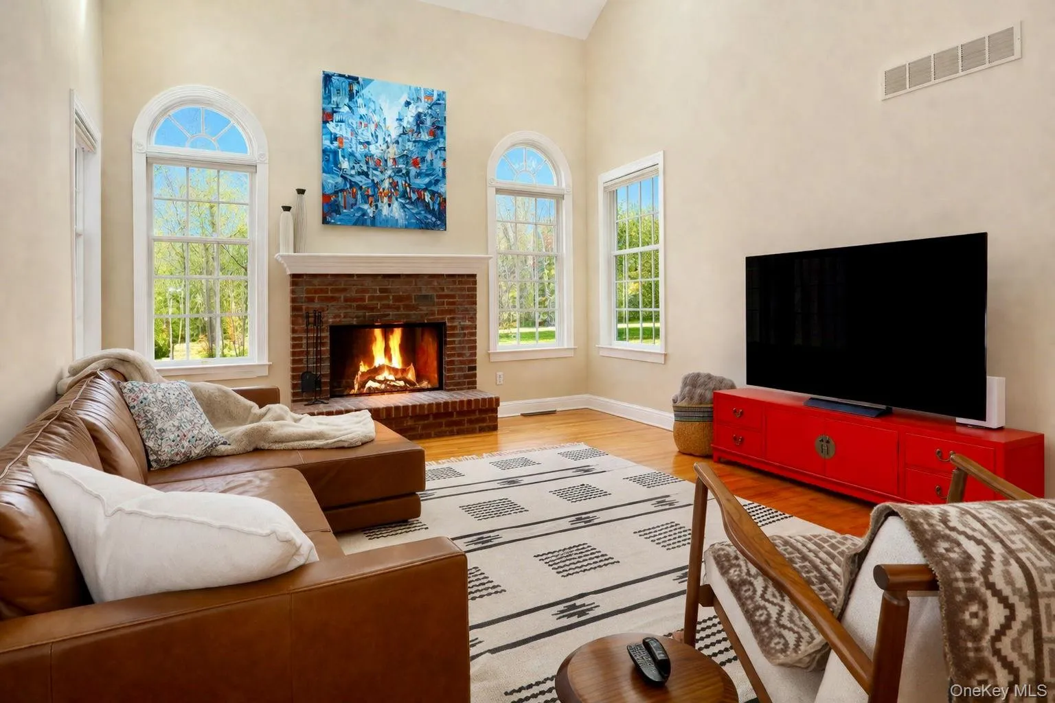 Family room with tree line views, sunlight, and a wood burning fireplace. Family room with tree line views, sunlight, and a wood burning fireplace.