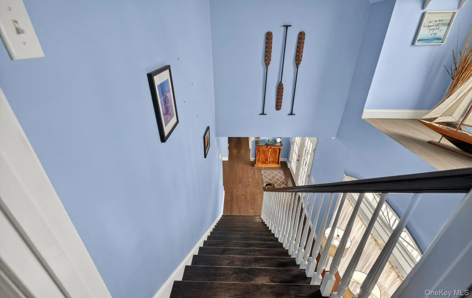 Staircase featuring baseboards and wood finished floors Staircase featuring baseboards and wood finished floors
