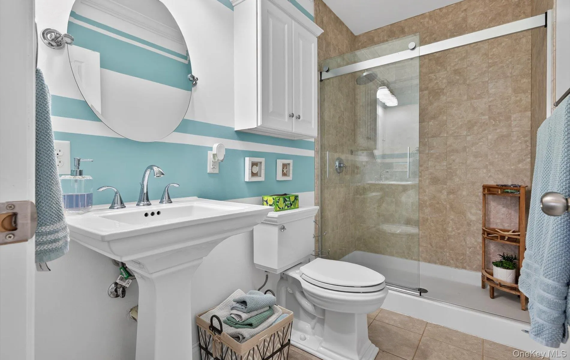 Full bathroom with a stall shower and light tile patterned floors Full bathroom with a stall shower and light tile patterned floors