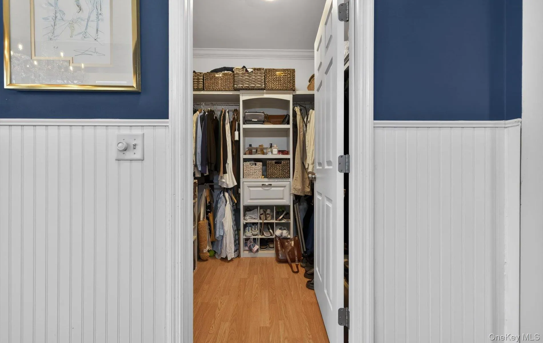 Walk in closet featuring light wood-style floors Walk in closet featuring light wood-style floors